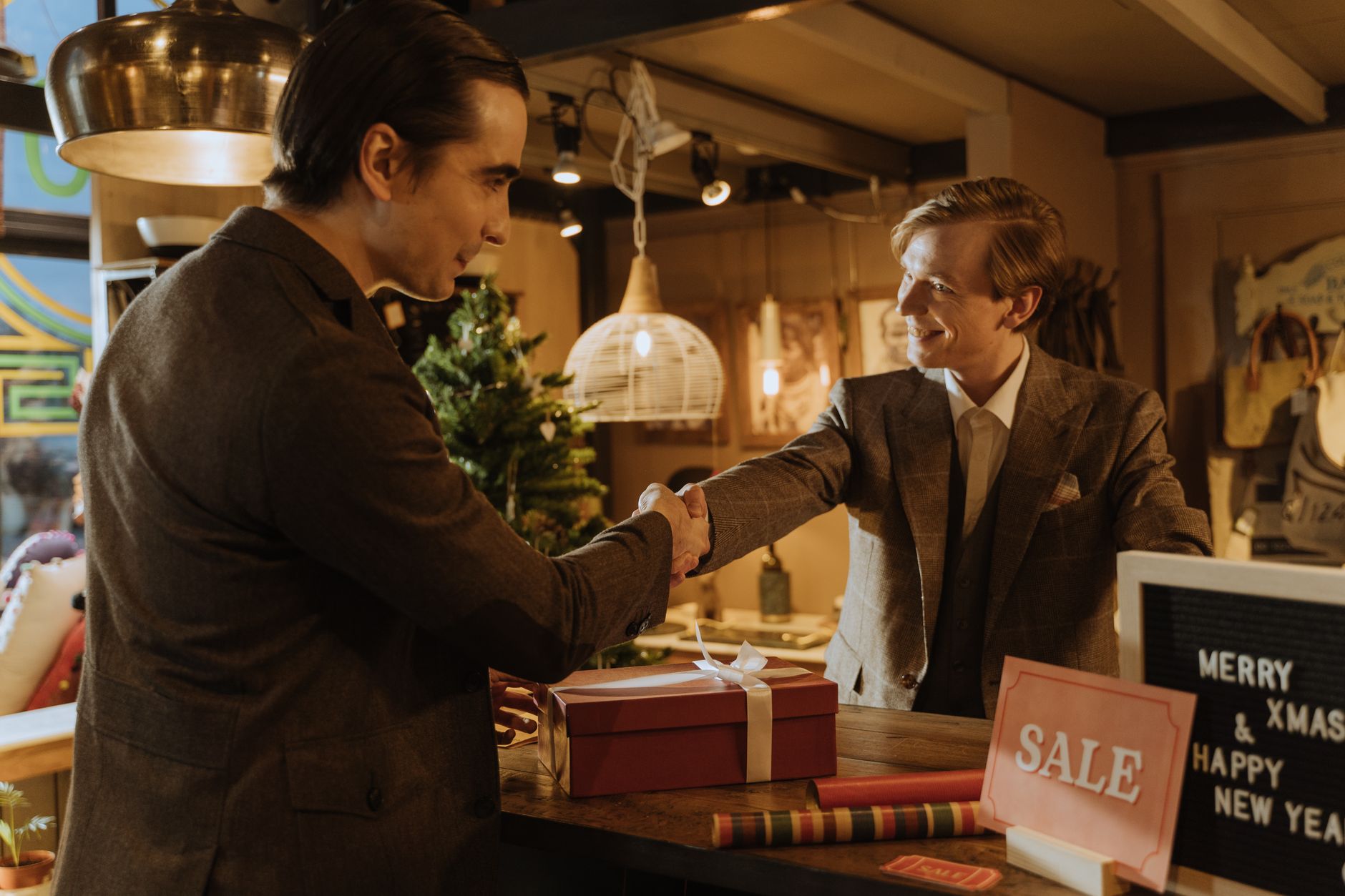 Two small business owners agreeing a cross-promotion partnership outside their shops