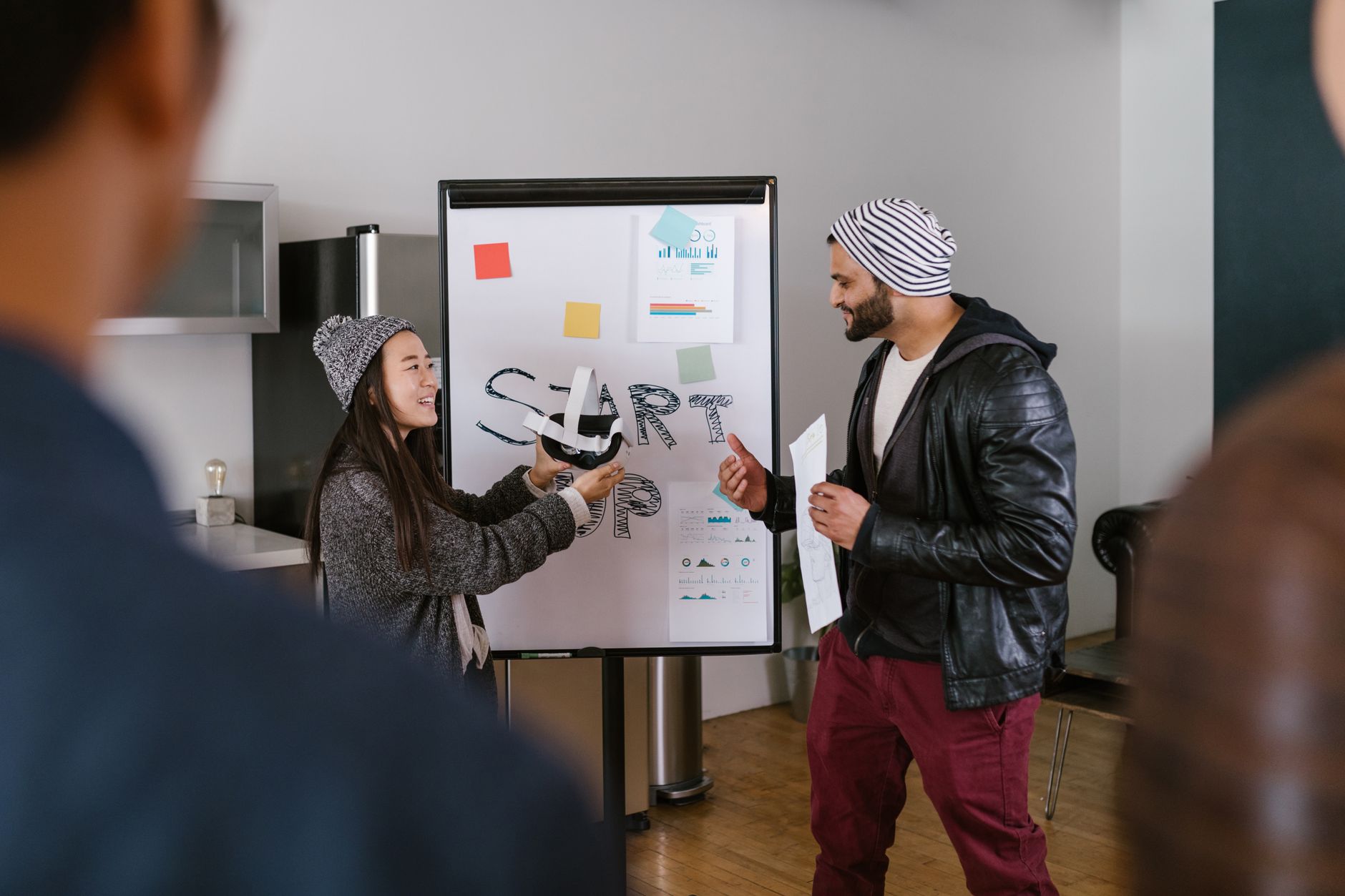 A small team mapping out marketing channels on a whiteboard