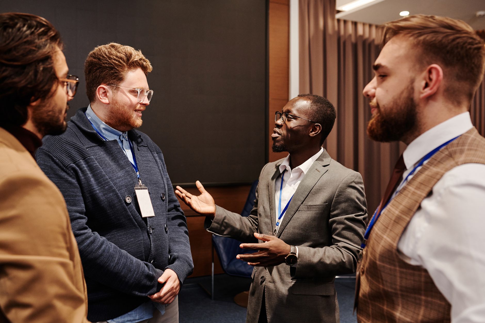 A founder talking through a problem with a potential customer at an event