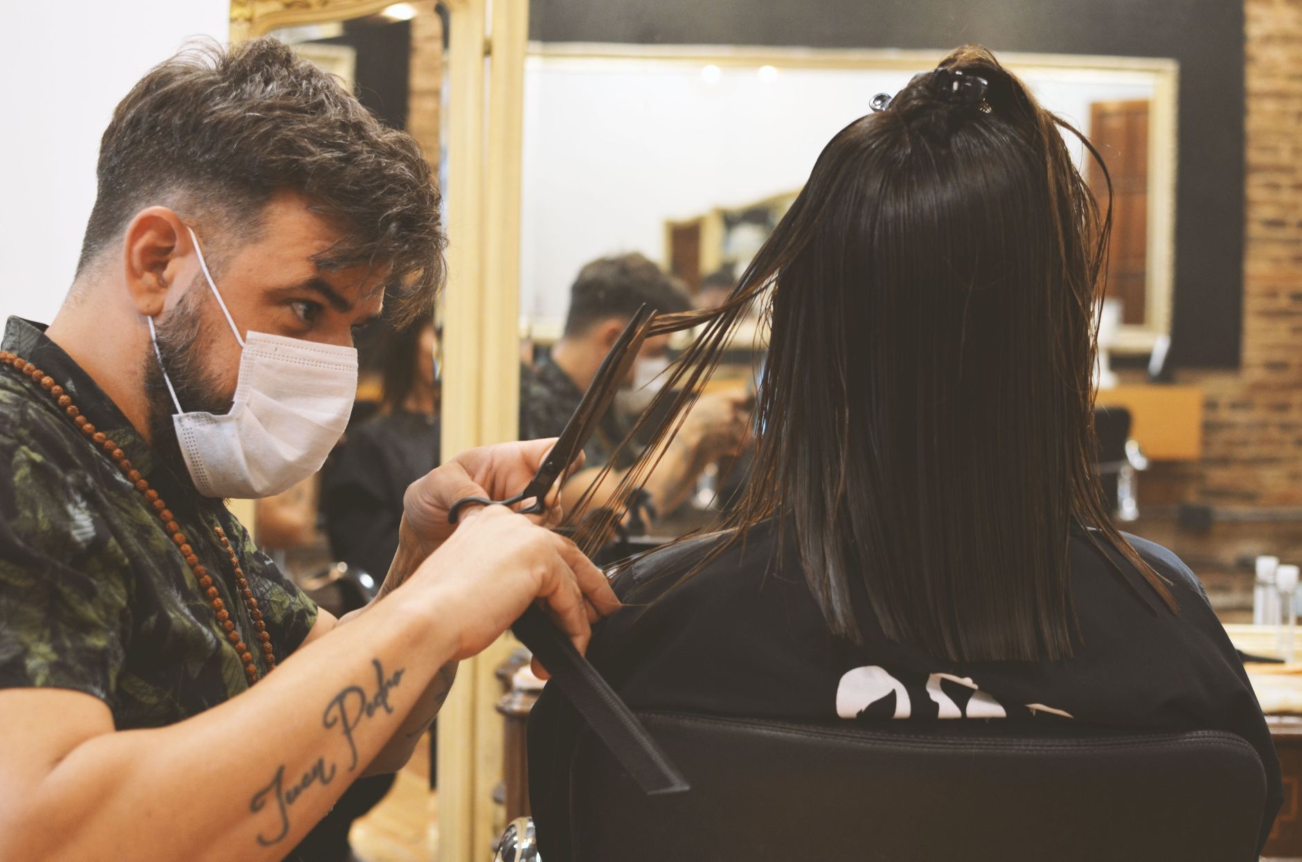 A hairdresser handing a client their products with a handwritten note