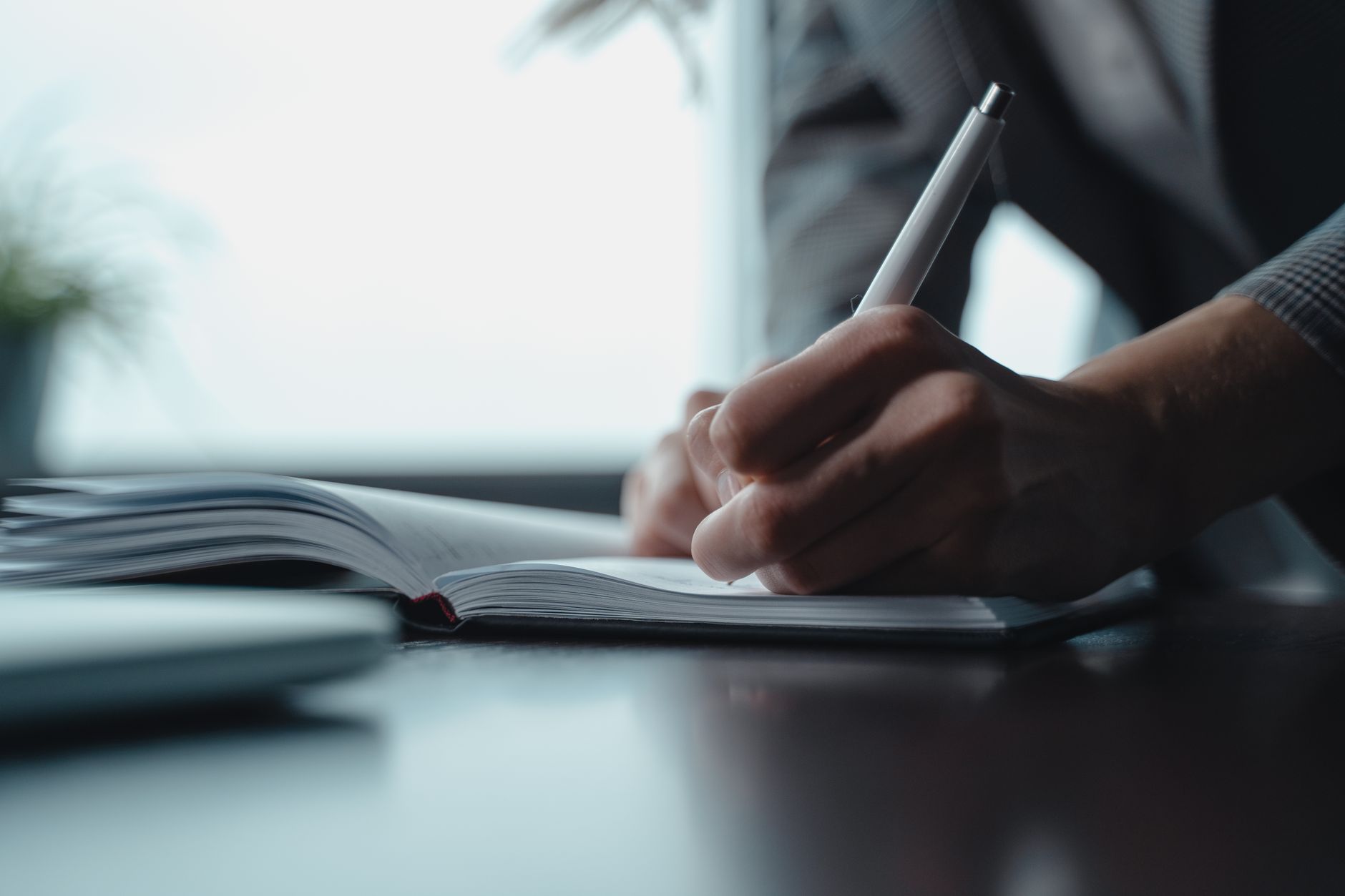 A business owner noting down a customer detail to remember later