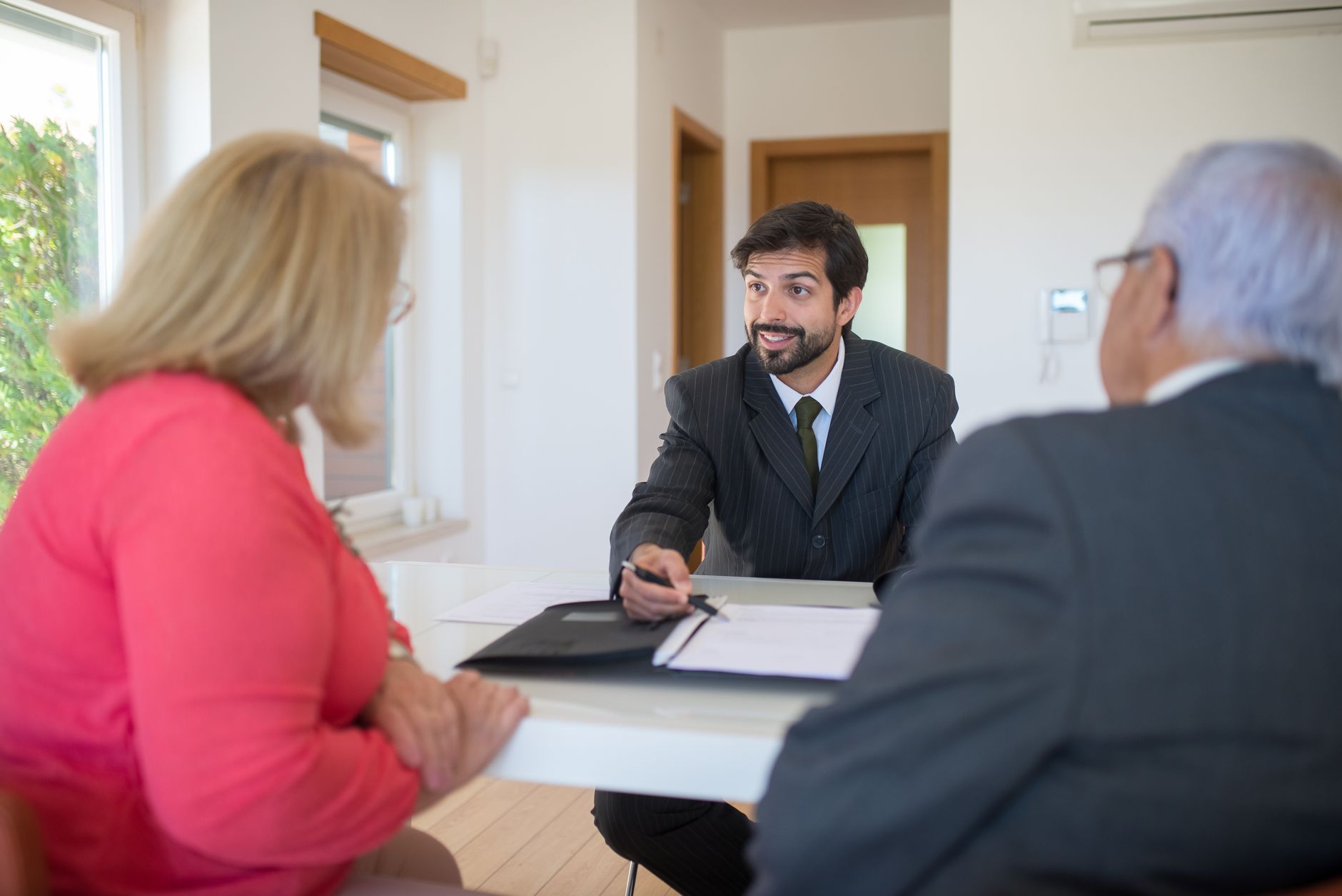 A financial adviser adding a thoughtful note after a client meeting