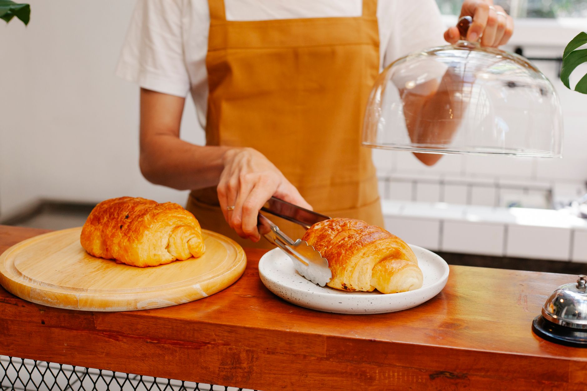 A baker serving a loyal customer who found them locally