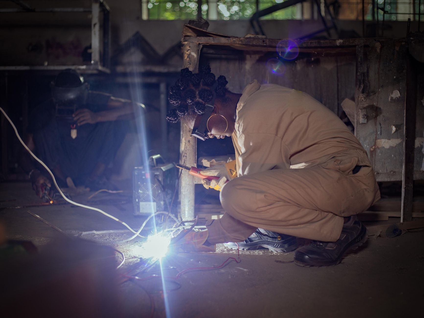An apprentice learning a trade alongside an experienced tradesperson