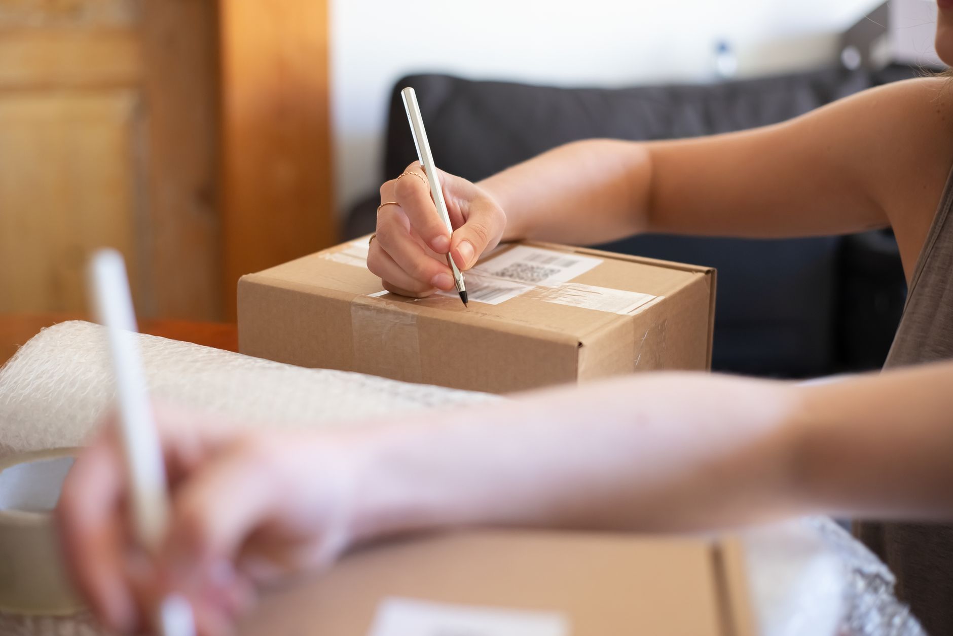 A customer opening a parcel that includes a personal handwritten note