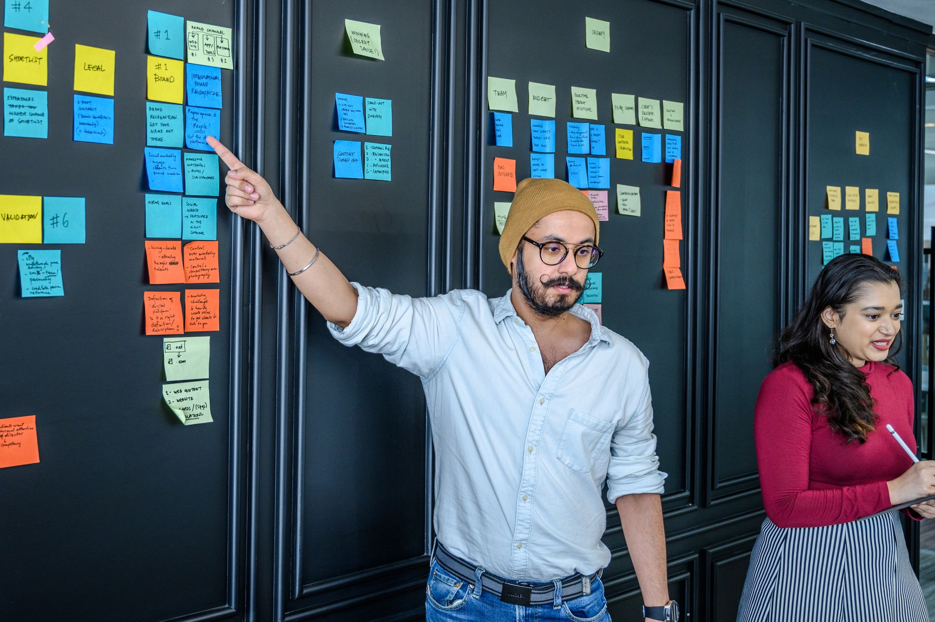 Coloured sticky notes grouped into clusters on a wall, illustrating how a small business sorts its email list into segments.