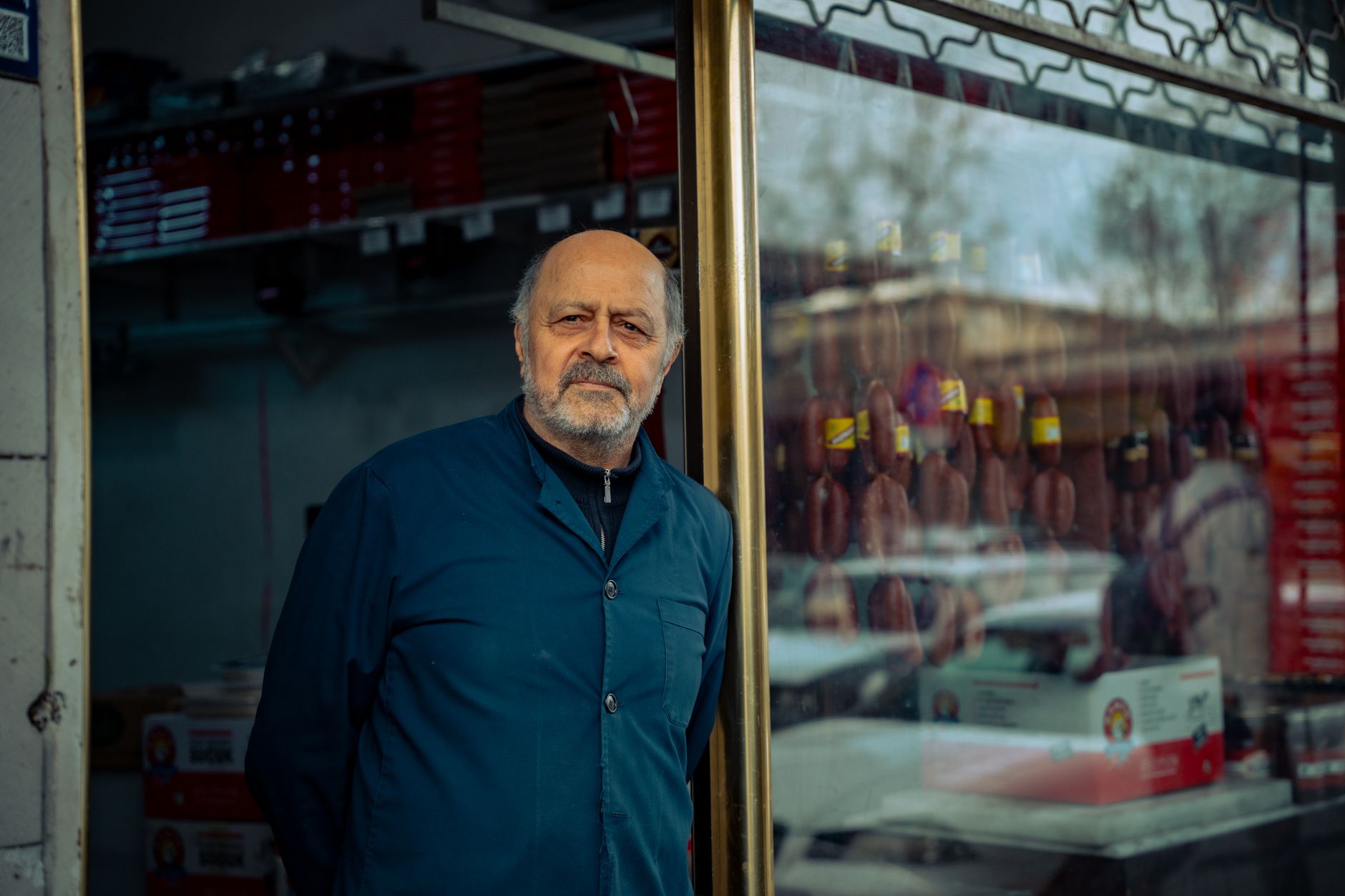 An independent shop owner outside their business