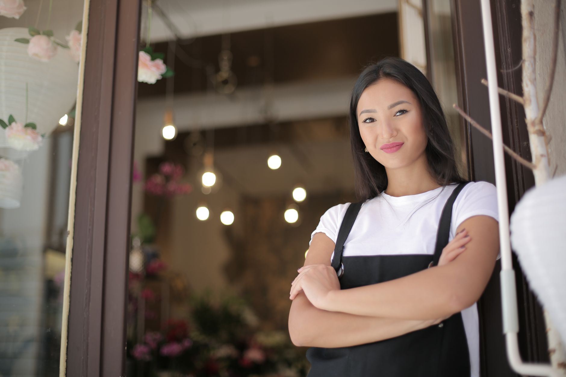 A small business owner standing confidently in their business