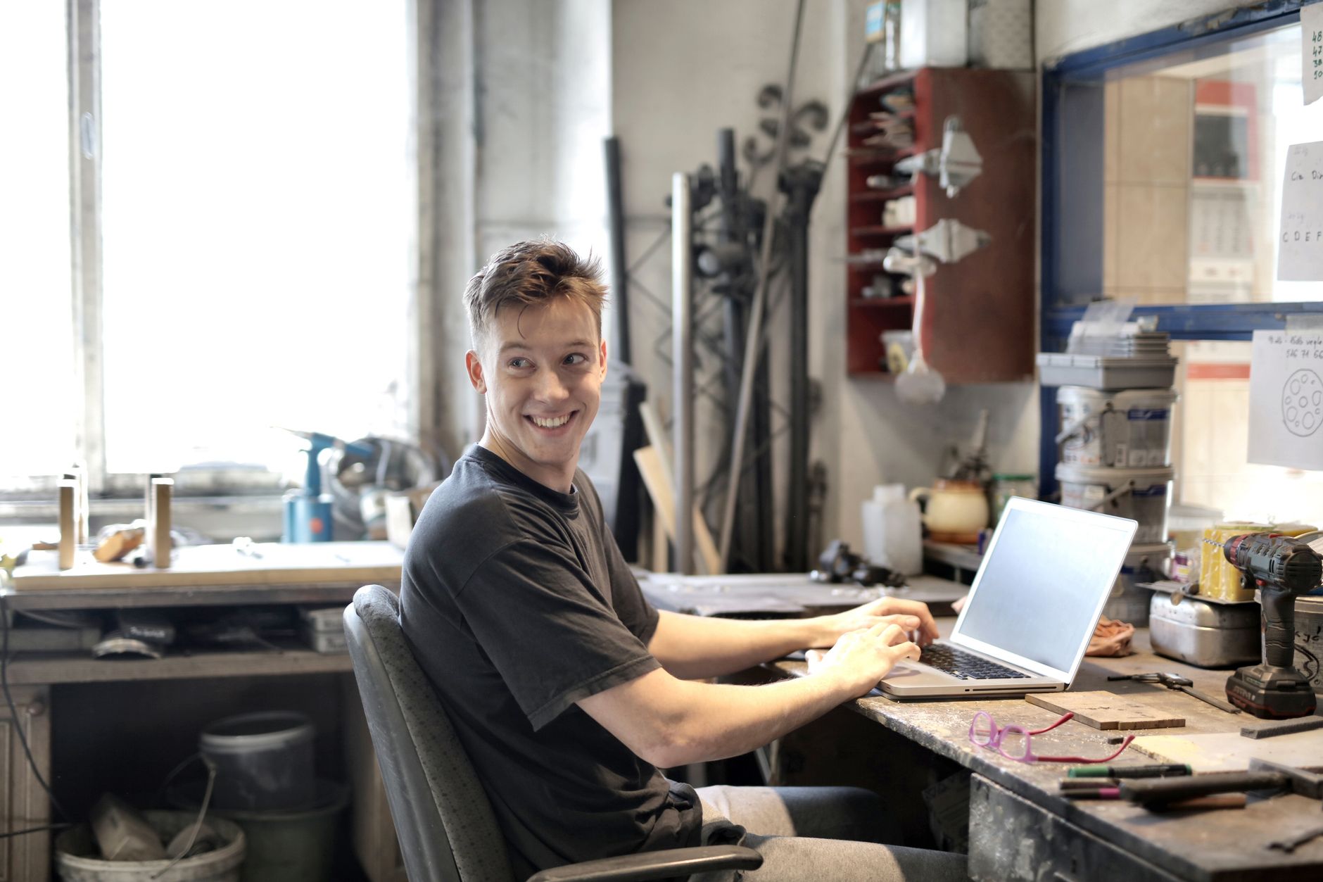A maker using new tools to market their workshop business