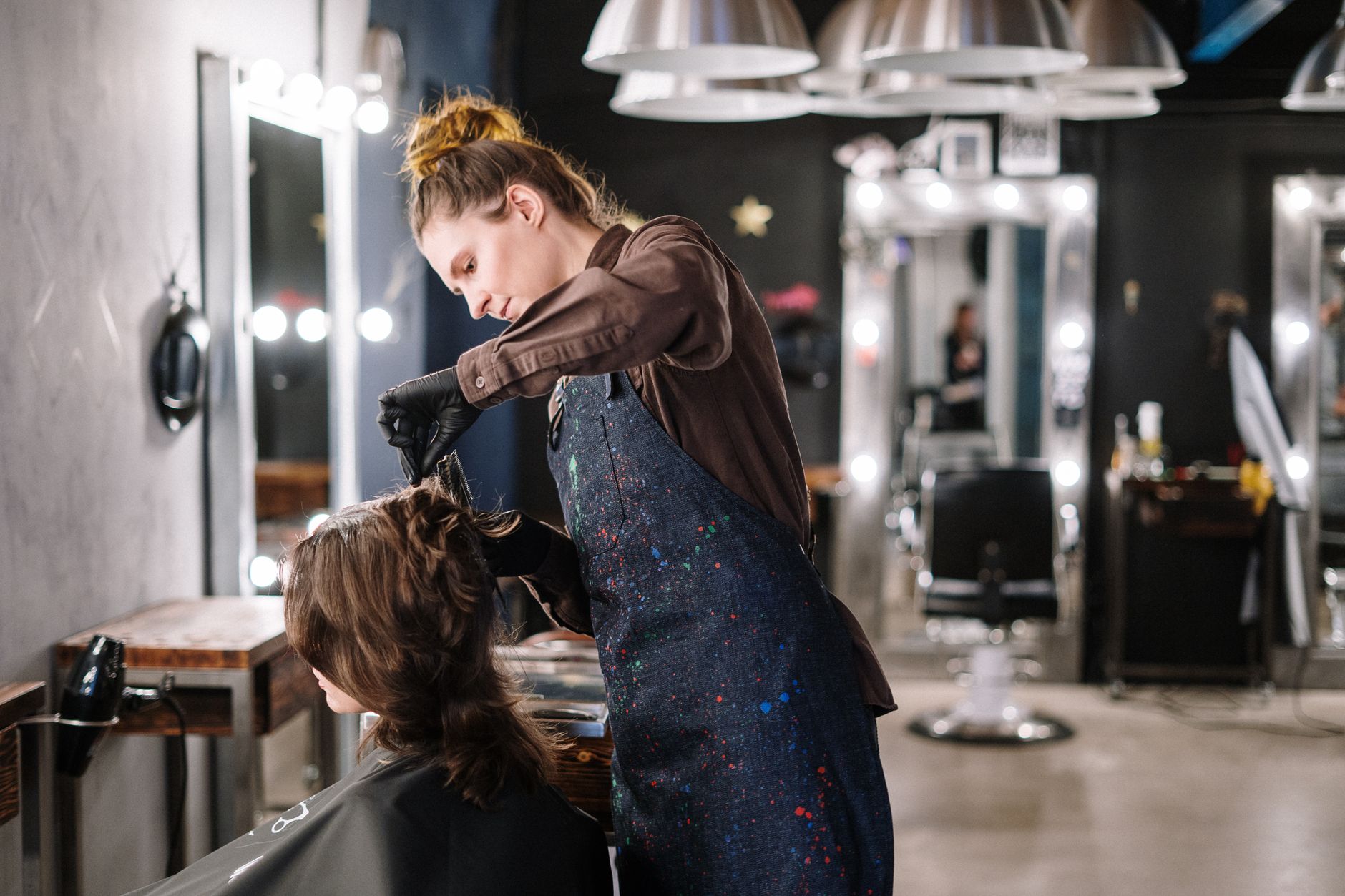 A hairdresser serving a client who found her through a recommendation