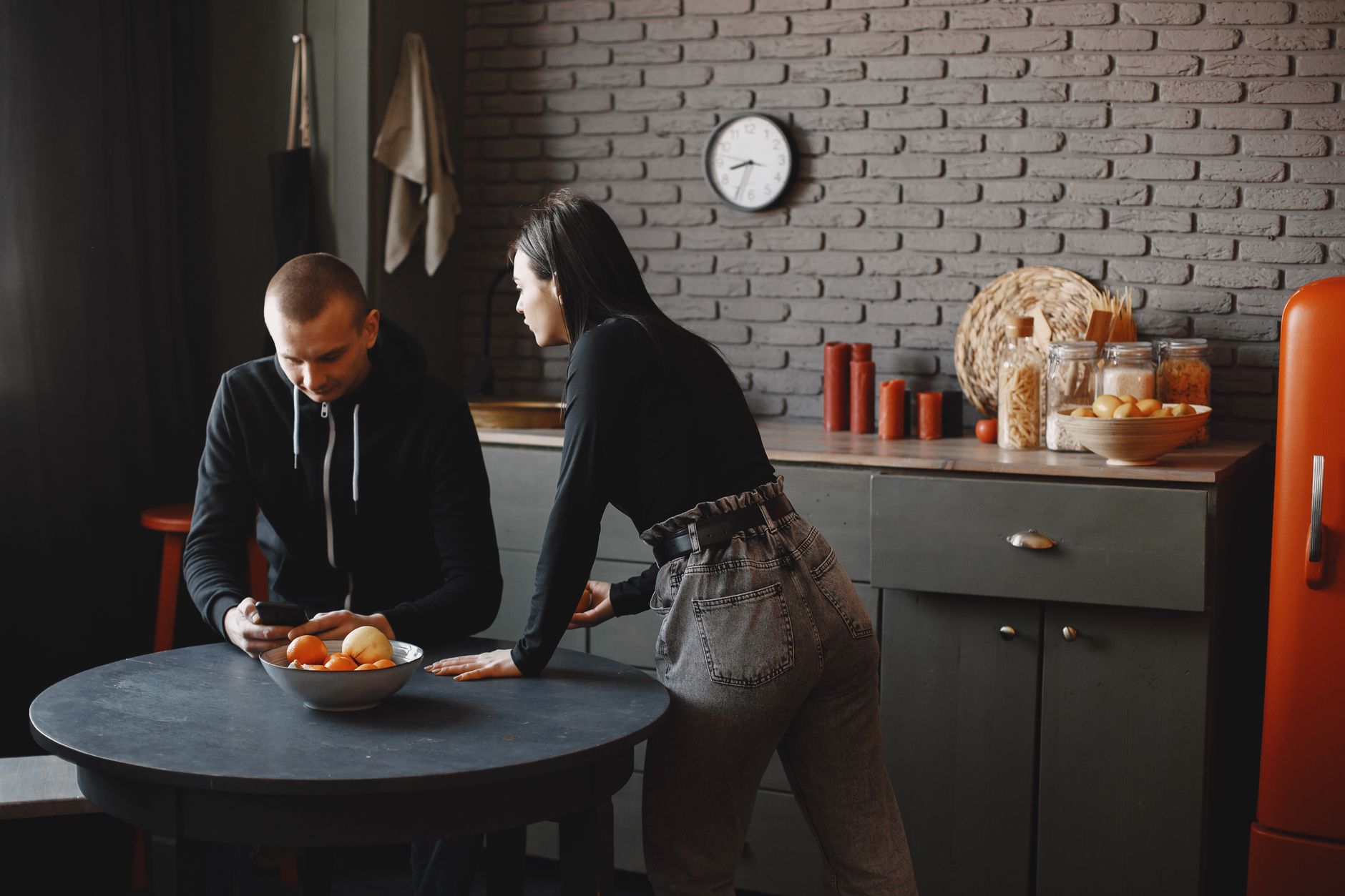 A couple comparing options on a phone while planning a home renovation
