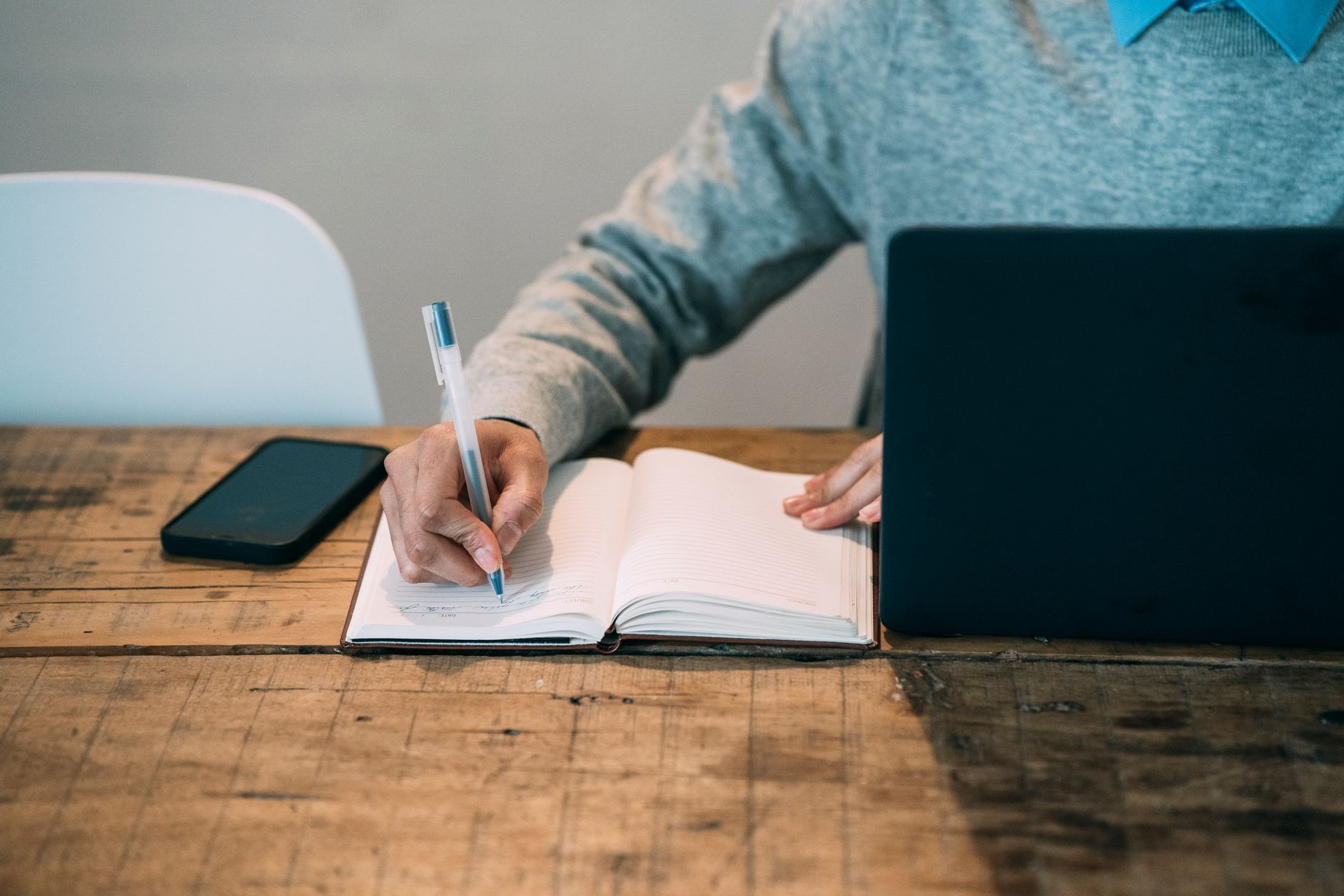 An owner writing clear, specific answers to customer questions for their website