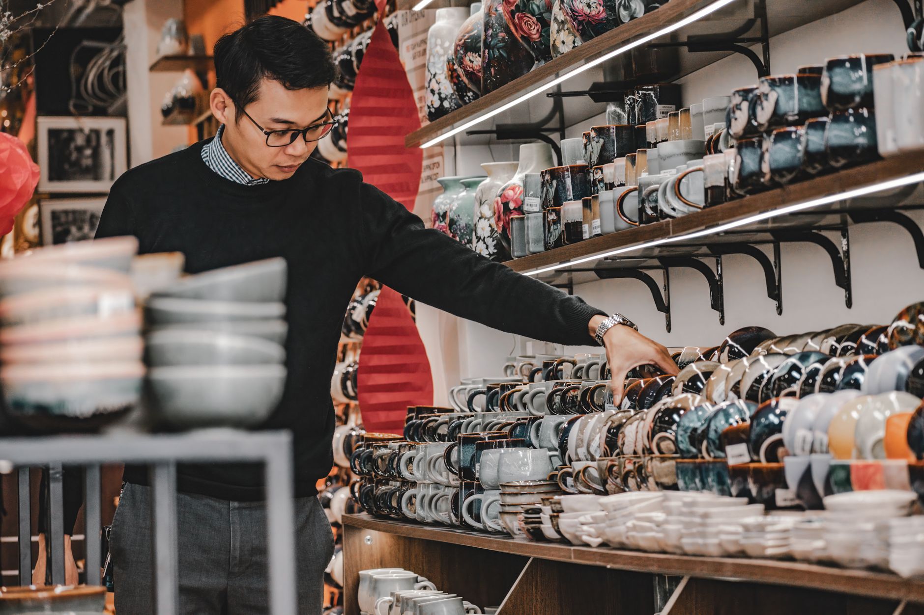 A customer browsing the shelves while holding a gift voucher