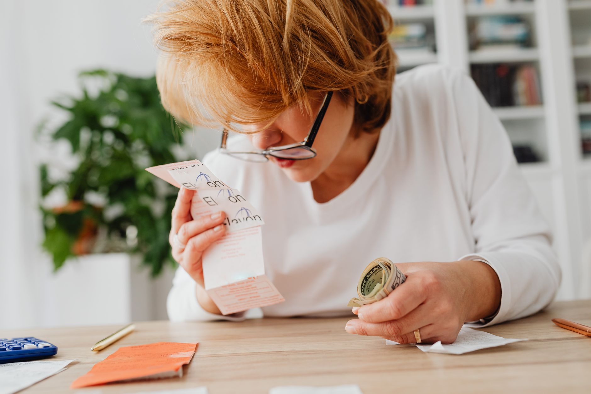 A business owner reviewing voucher records at a back office desk