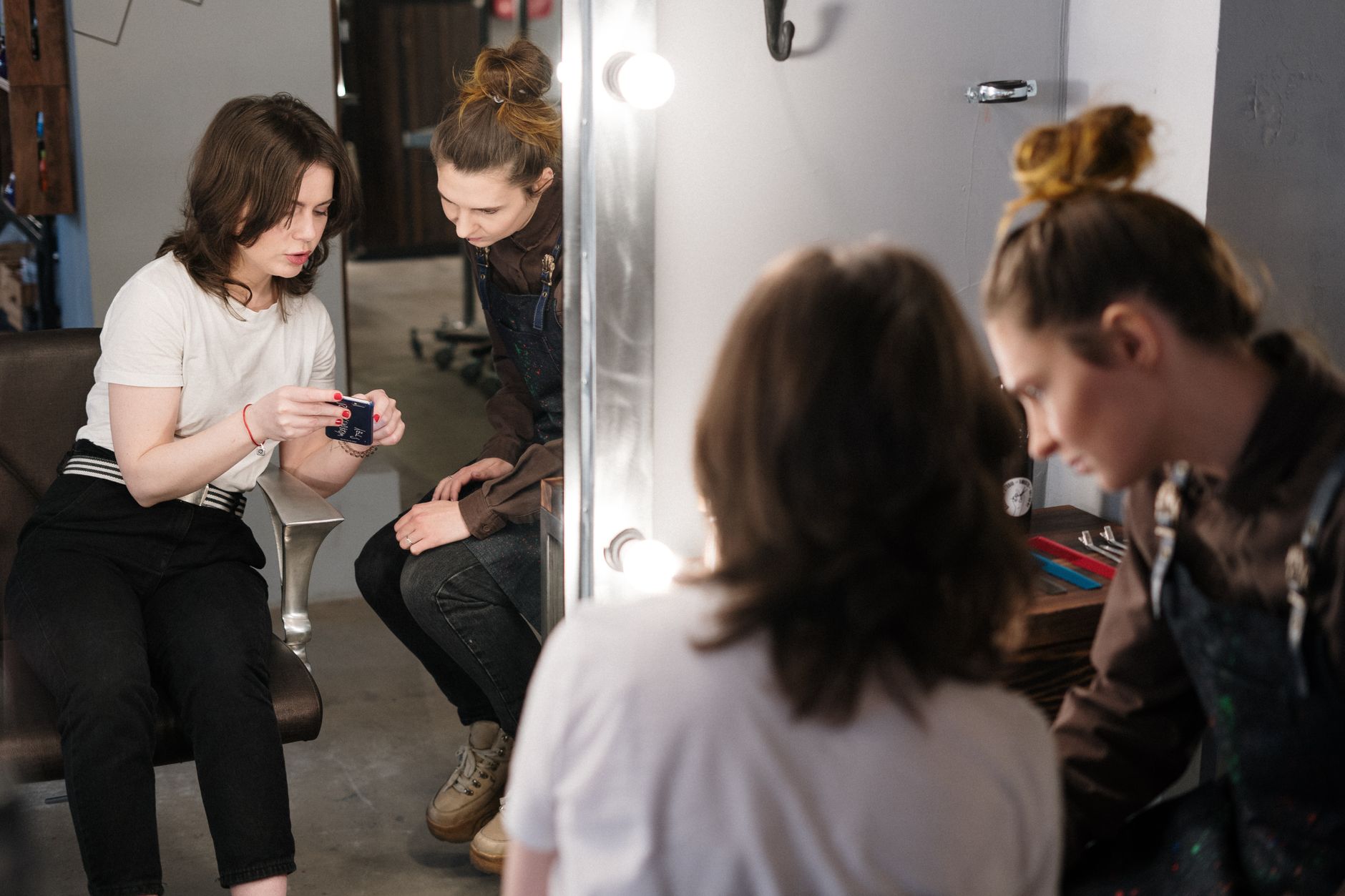 A hairdresser showing a customer a gift voucher display stand