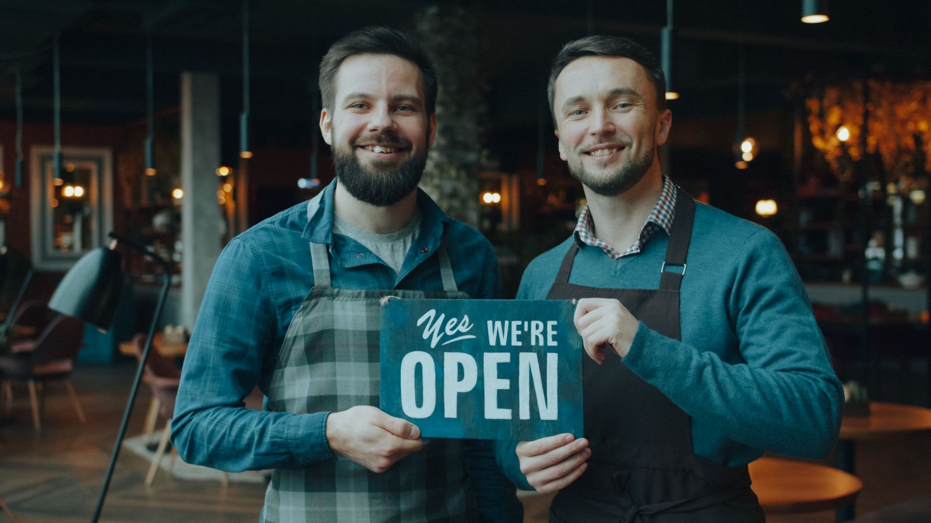 Two independent shop owners comparing ideas to boost sales