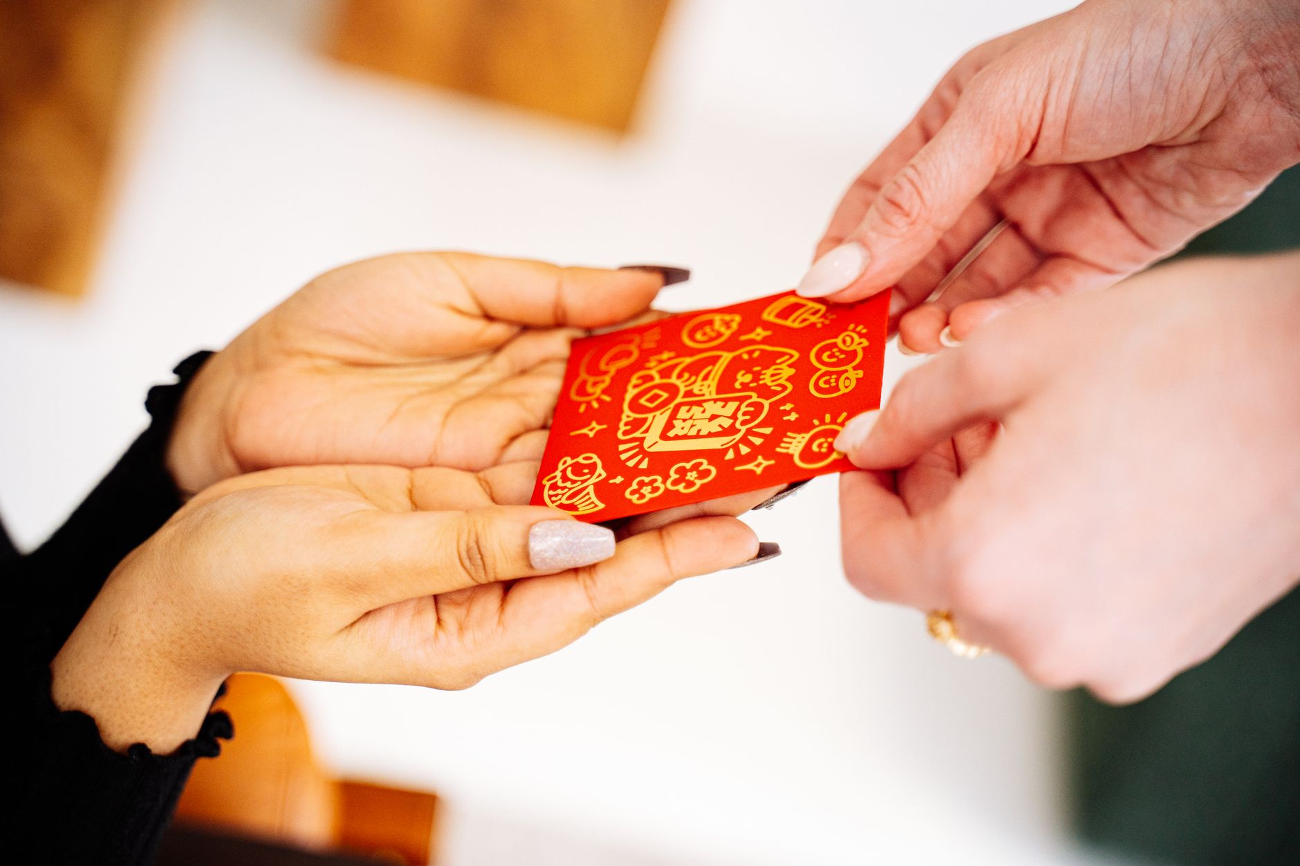 A shop assistant handing a gift voucher to a customer at the counter