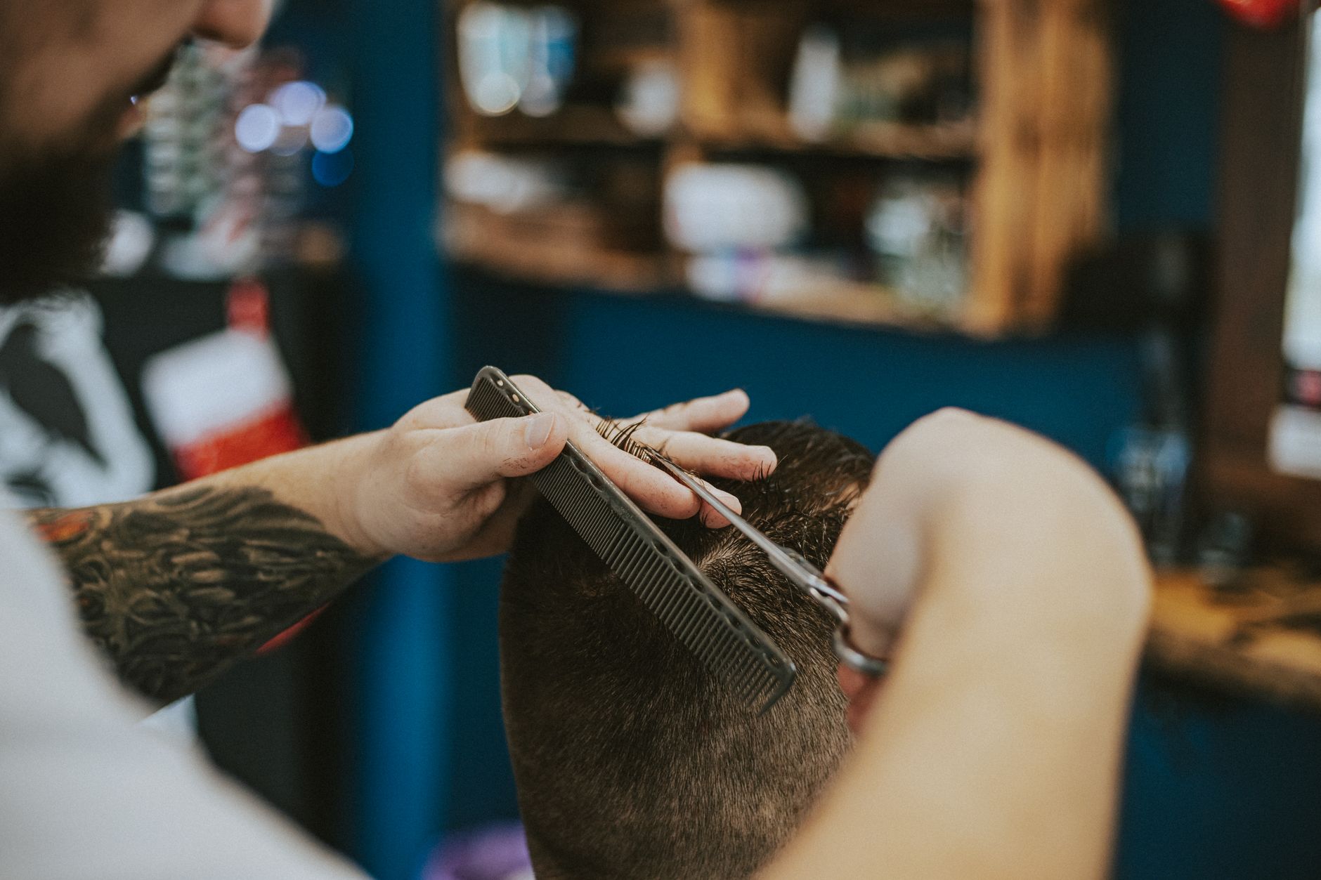 A hairdresser serving a customer in her local salon