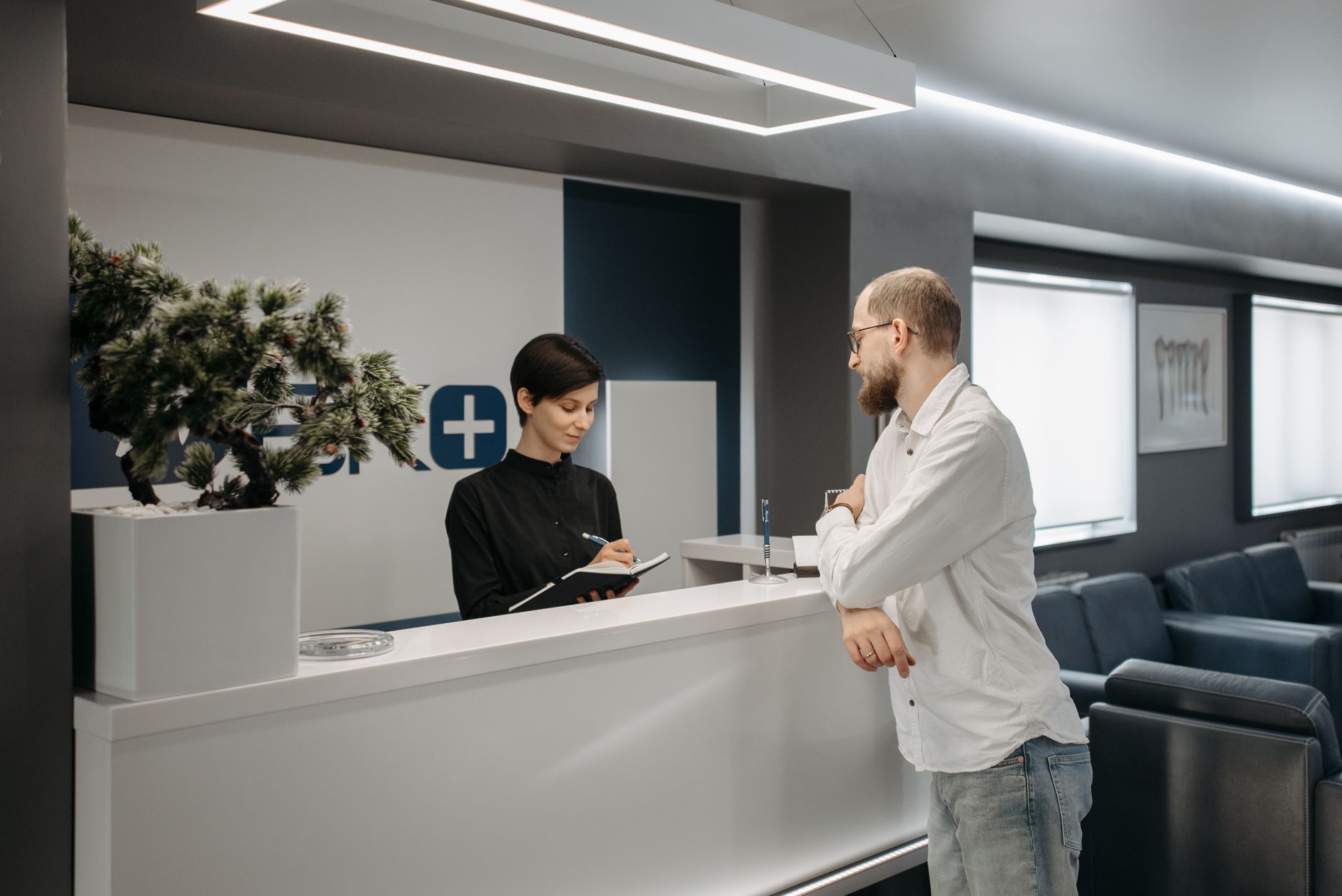 A patient searching for information on their phone in a clinic waiting room