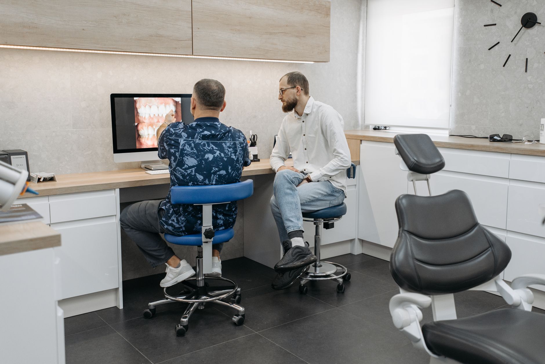 A dentist checking new patient enquiries at their desk