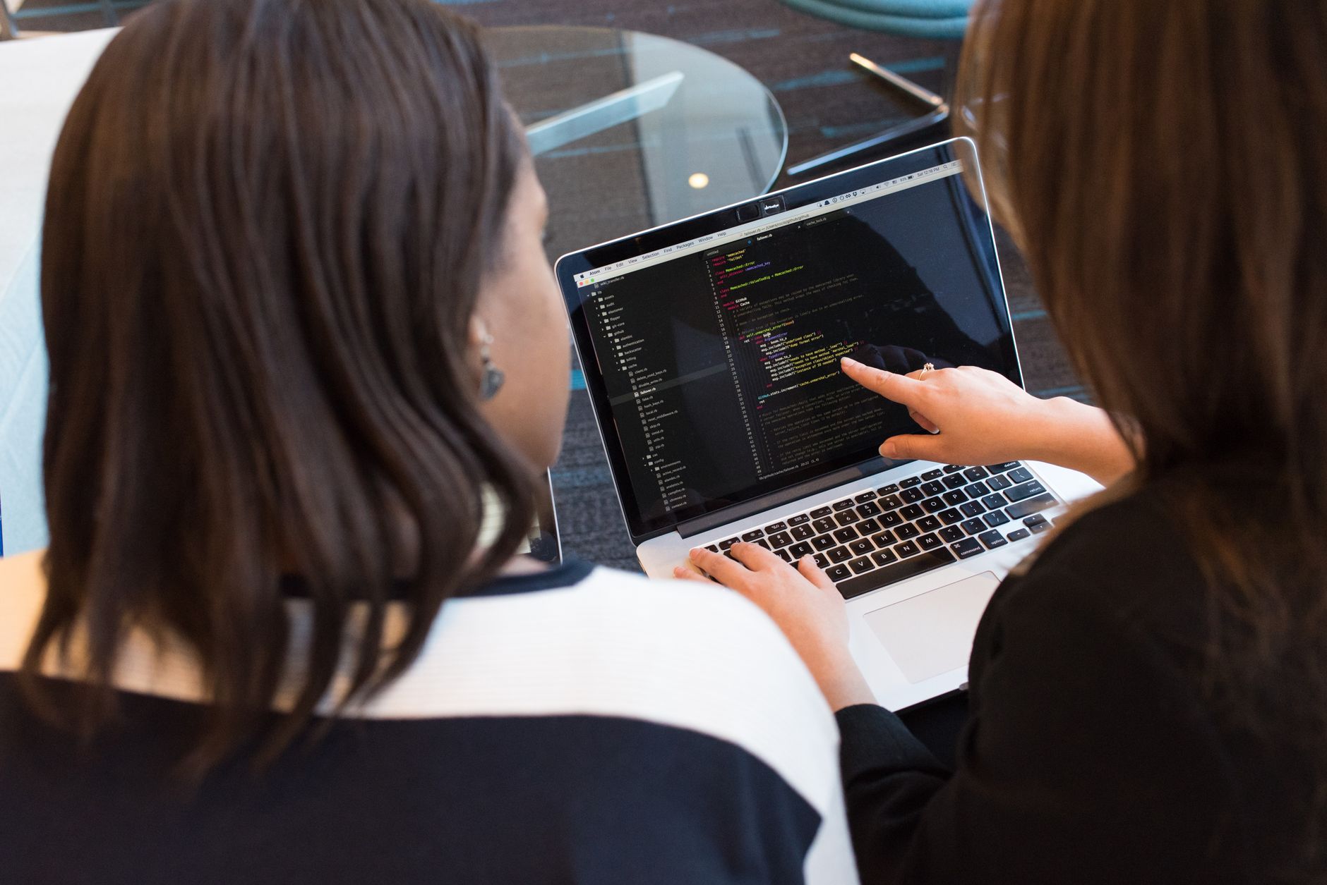 A business owner working with a web developer to set up their website tracking