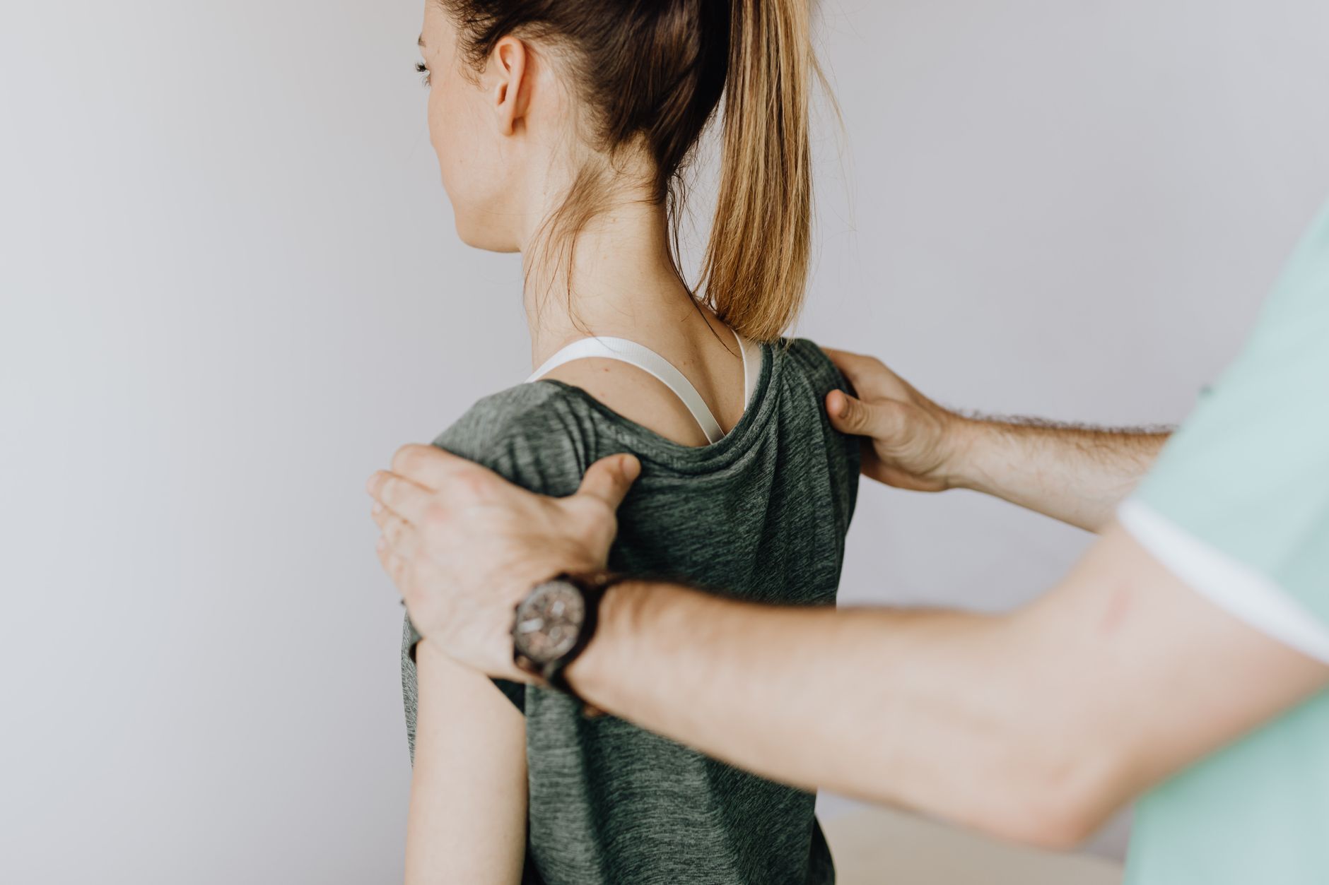 An osteopath treating a patient in a well-kept treatment room