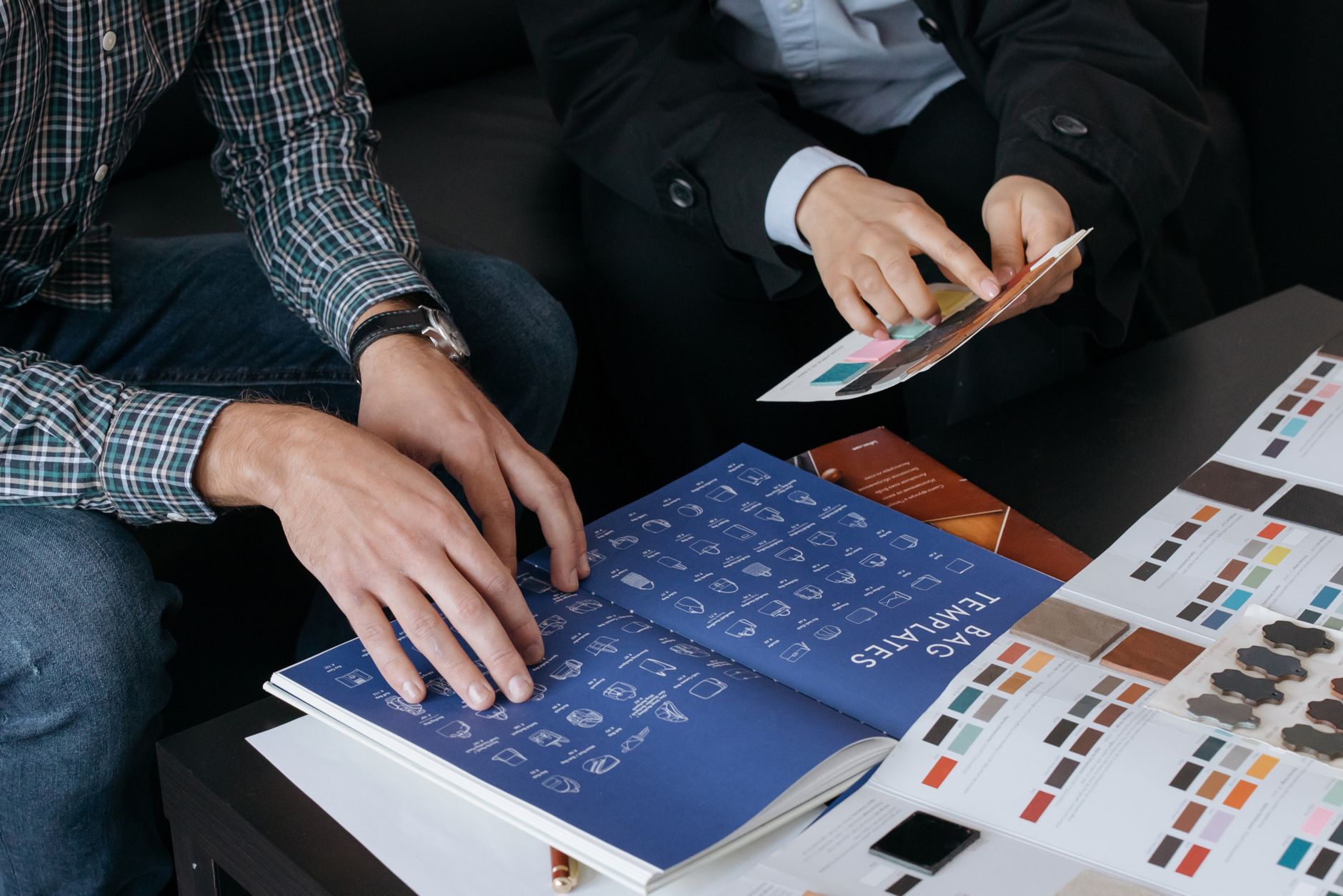 Two designers reviewing packaging samples for a client