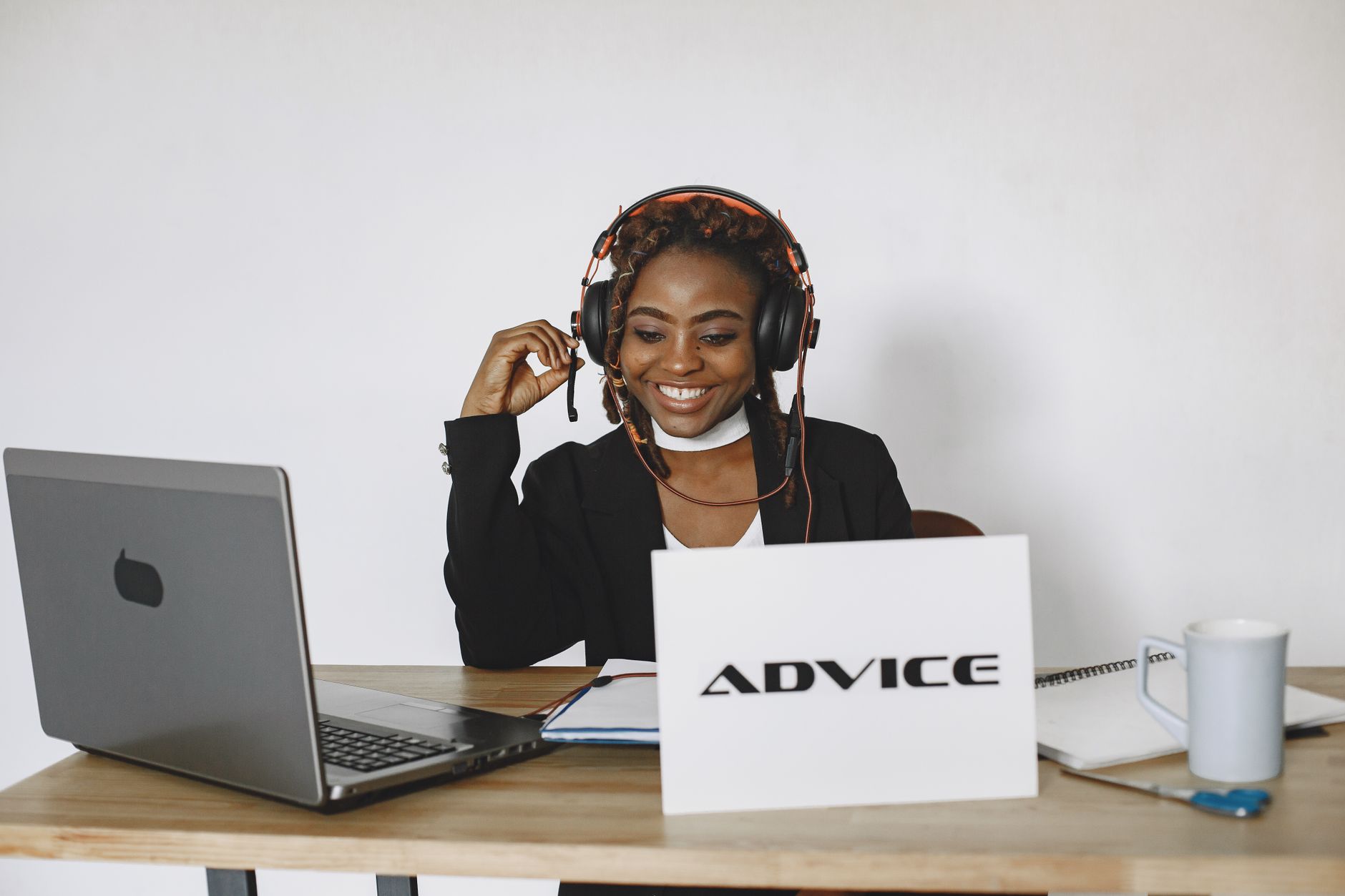 A coach speaks with a prospective client on a video call from a calm office, leaning in to listen during a structured discovery conversation.