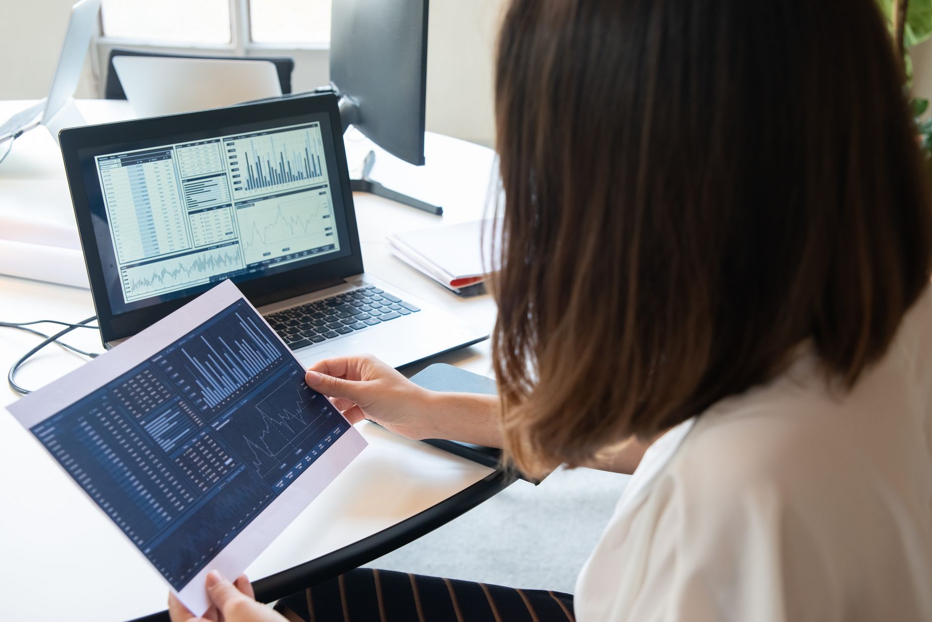 A business owner reviews her Instagram growth figures on a laptop, tracking new followers across twelve weeks of steady posting.