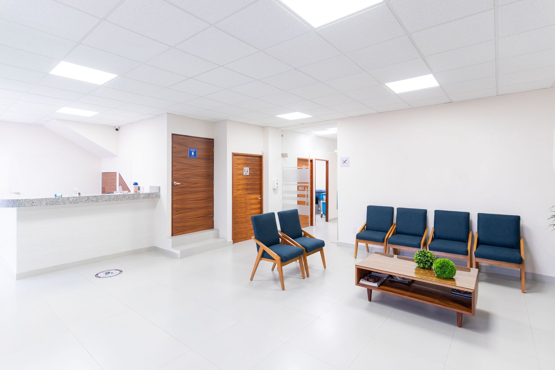 A clear, simple price list displayed at a wellbeing clinic reception