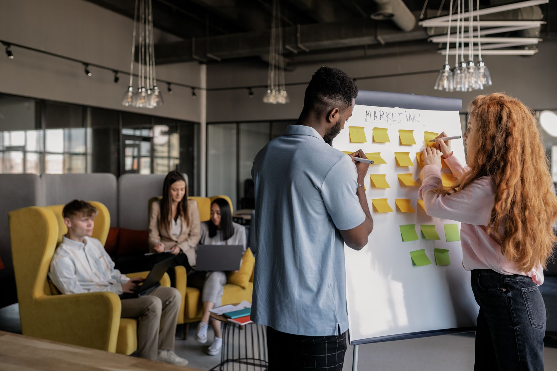 A small business owner maps out a single new marketing channel on a whiteboard before committing to it.