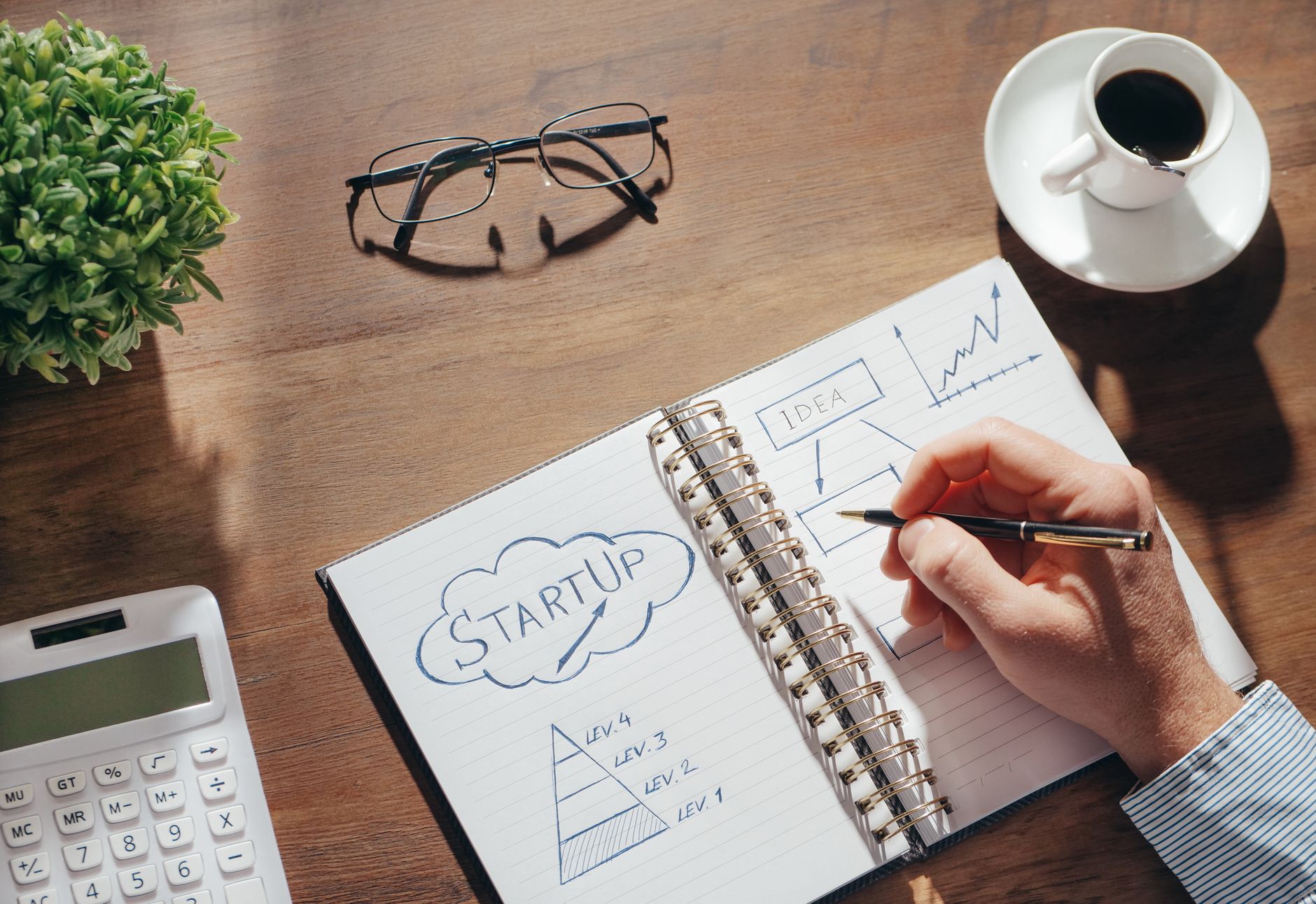 A service business owner reviews a steadily rising chart of clients and enquiries on a desk while deciding where to focus next.