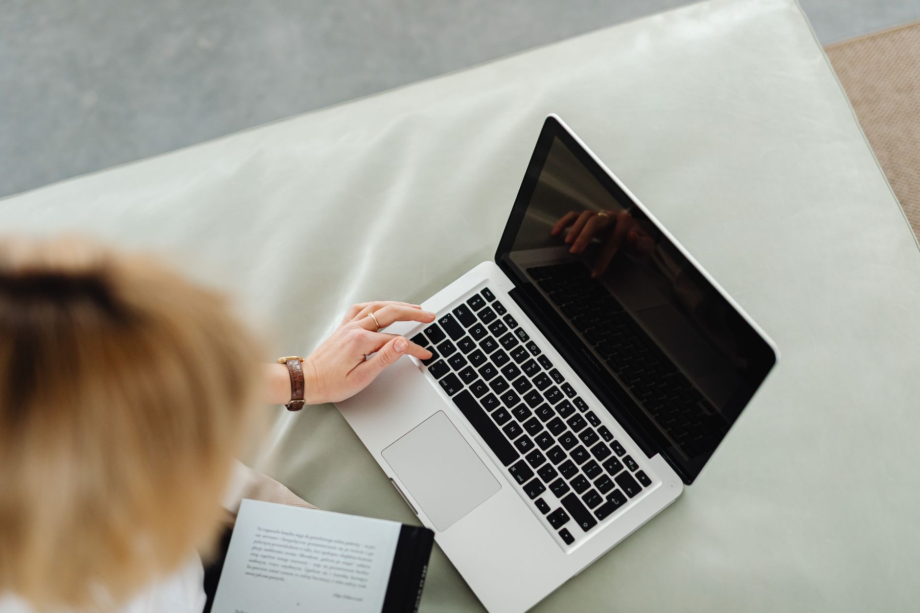 A customer completes a quick online booking on a laptop, tapping through a clean two-step form with no clutter on the screen.