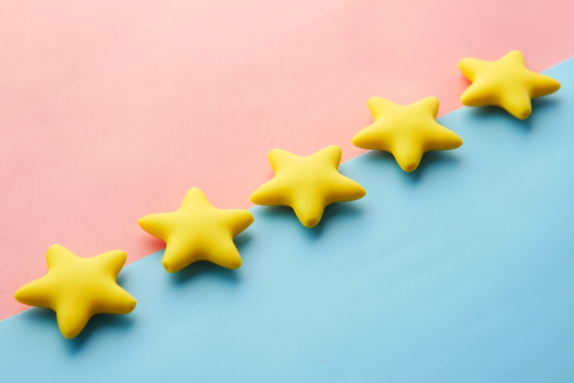 Five wooden blocks each showing a star arranged on a desk, representing a strong, genuine five-star review profile