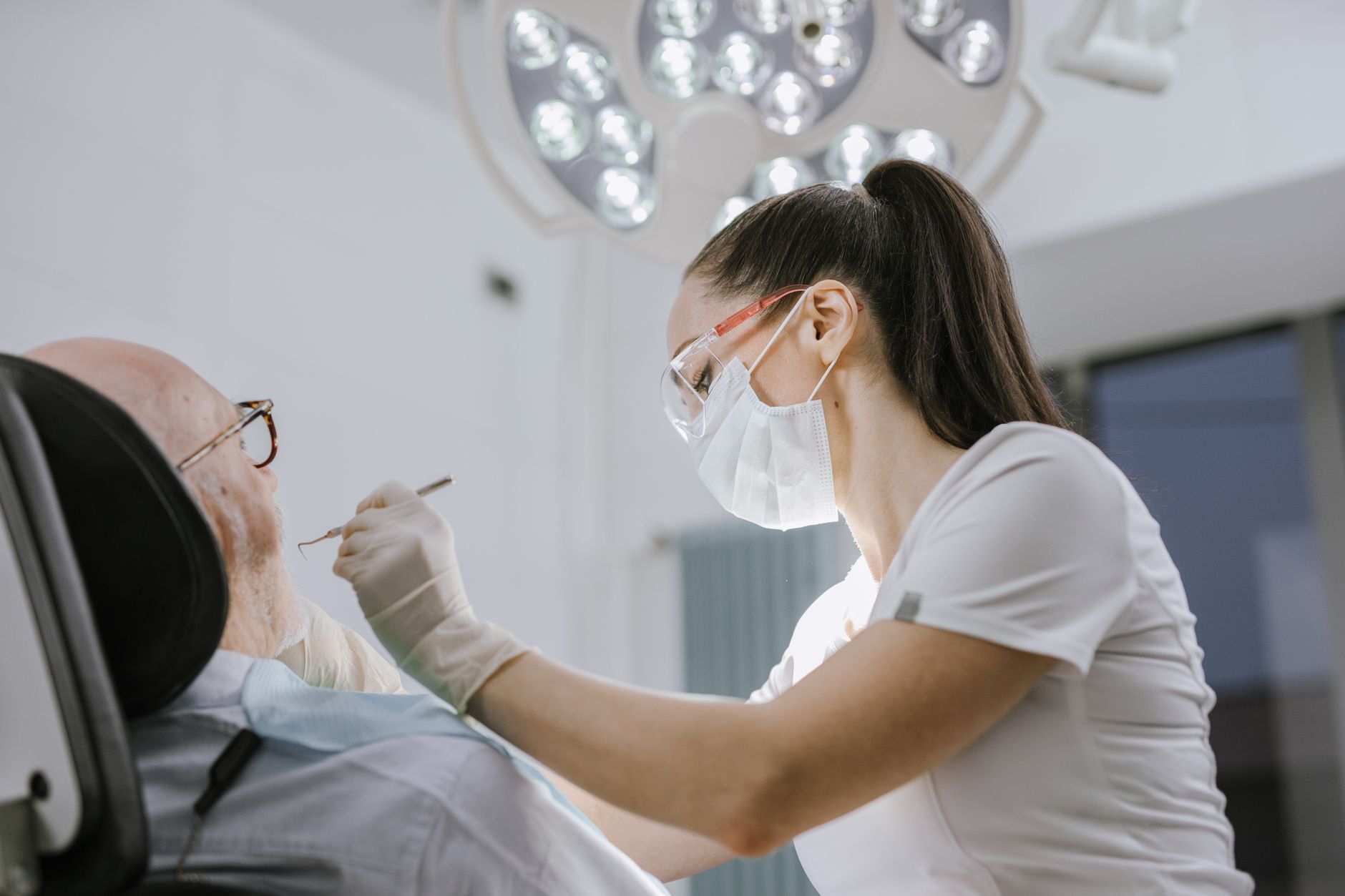 A clinician makes a friendly recall reminder call to a returning patient from a quiet consultation room.