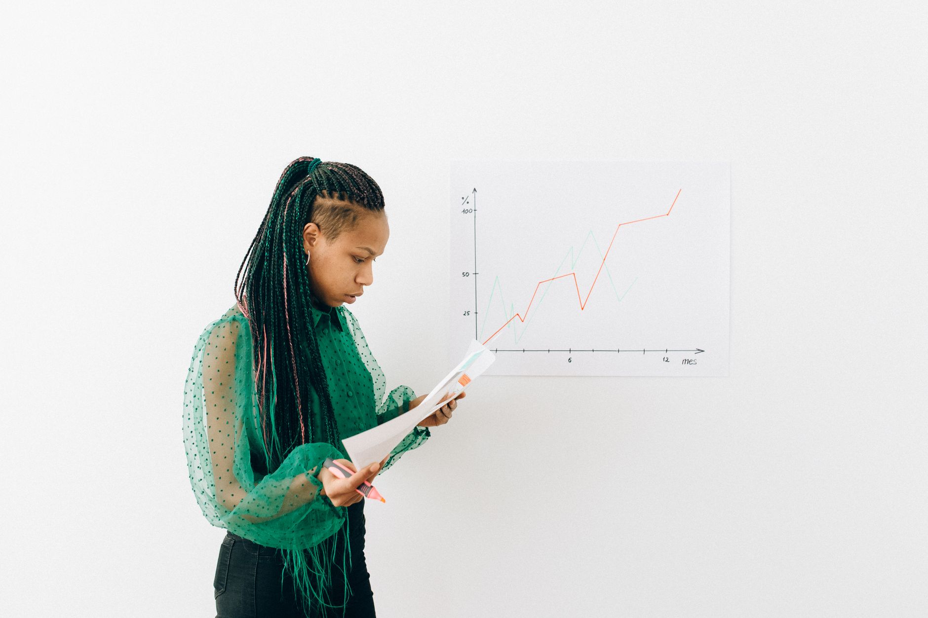 A coach reviews a client's progress chart together with them, both pleased at the visible result the work has produced.