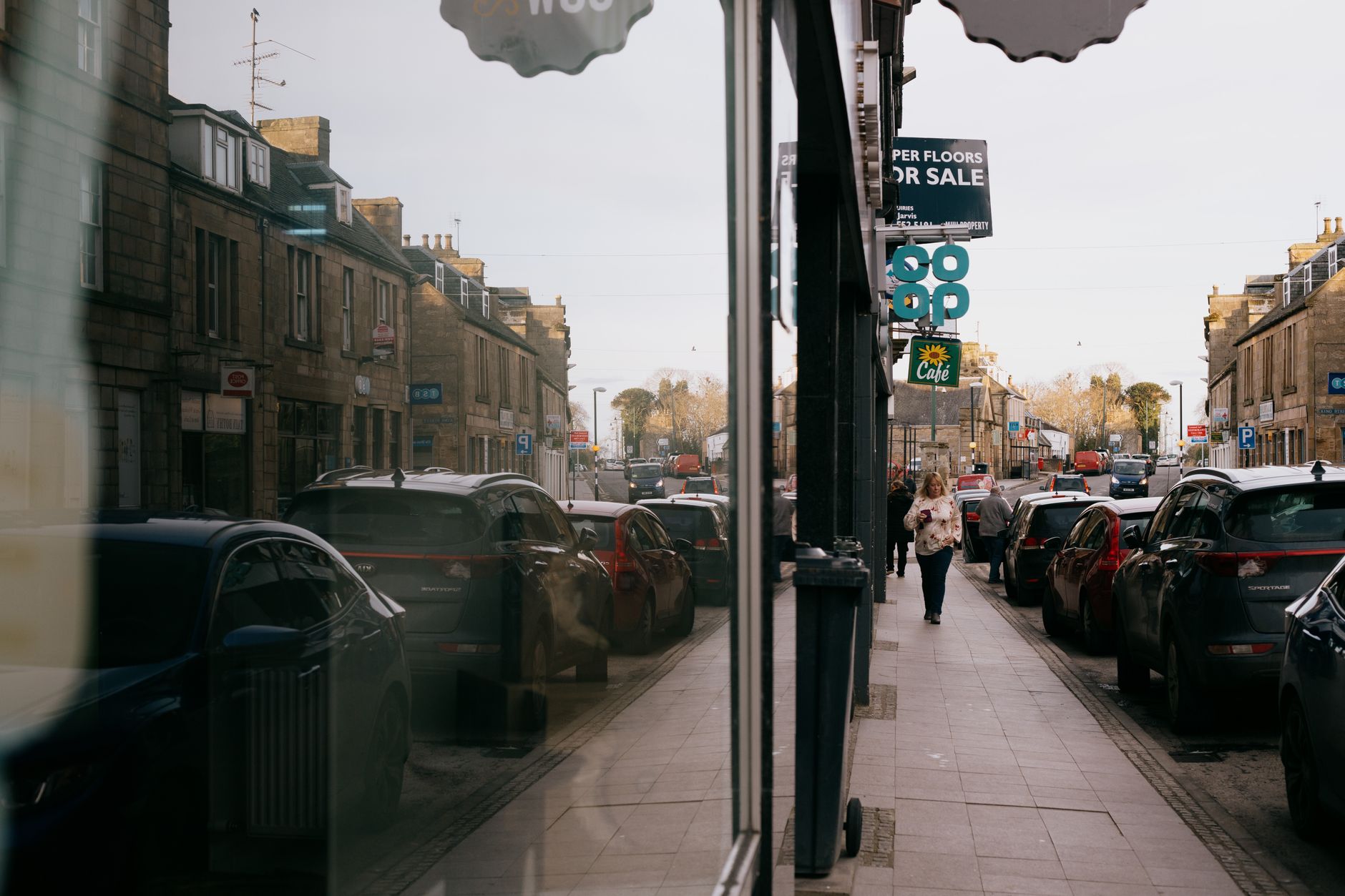 A quiet high street with fewer shoppers passing independent shops