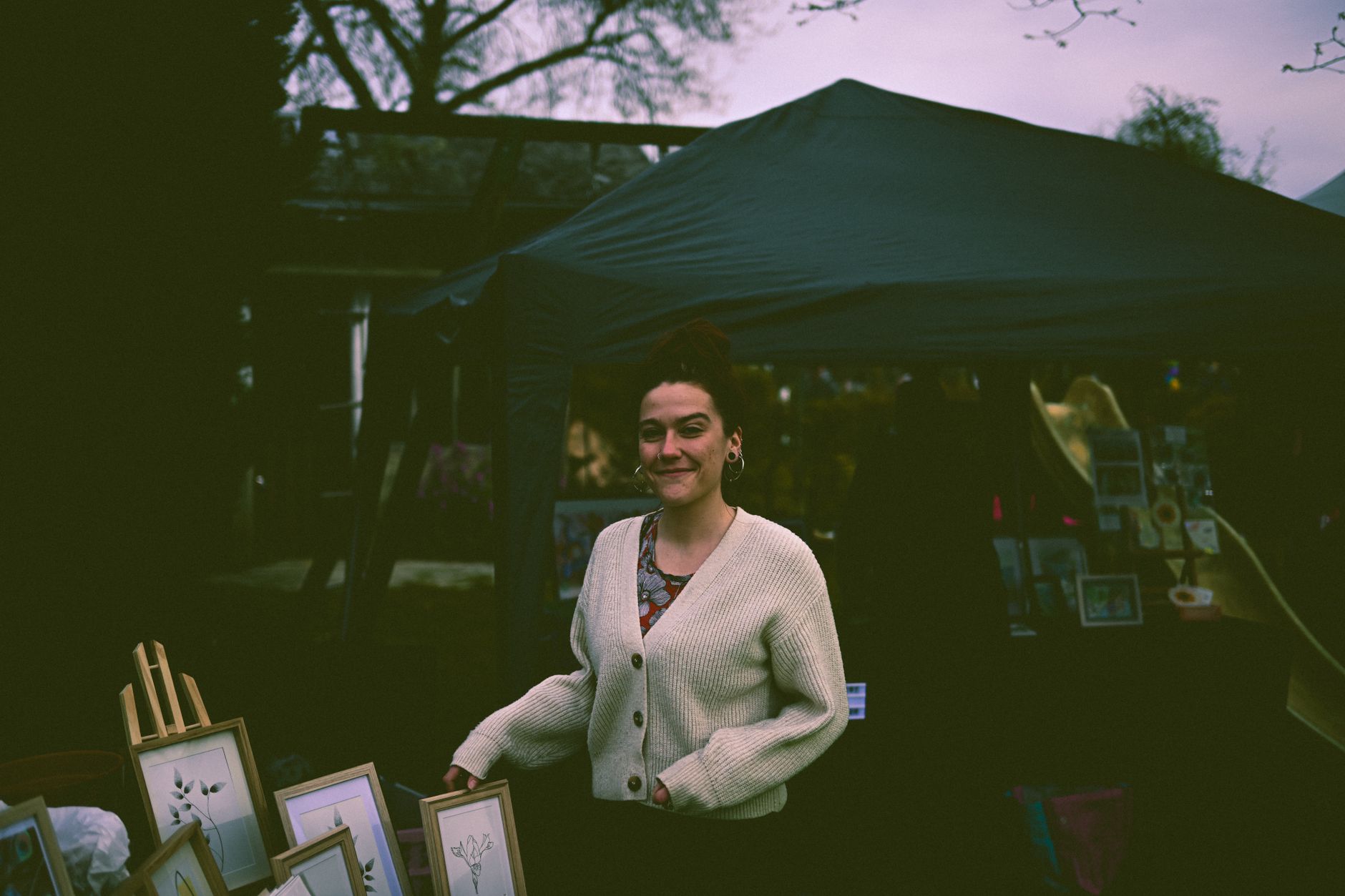 A market trader welcoming a first-time customer to their stall