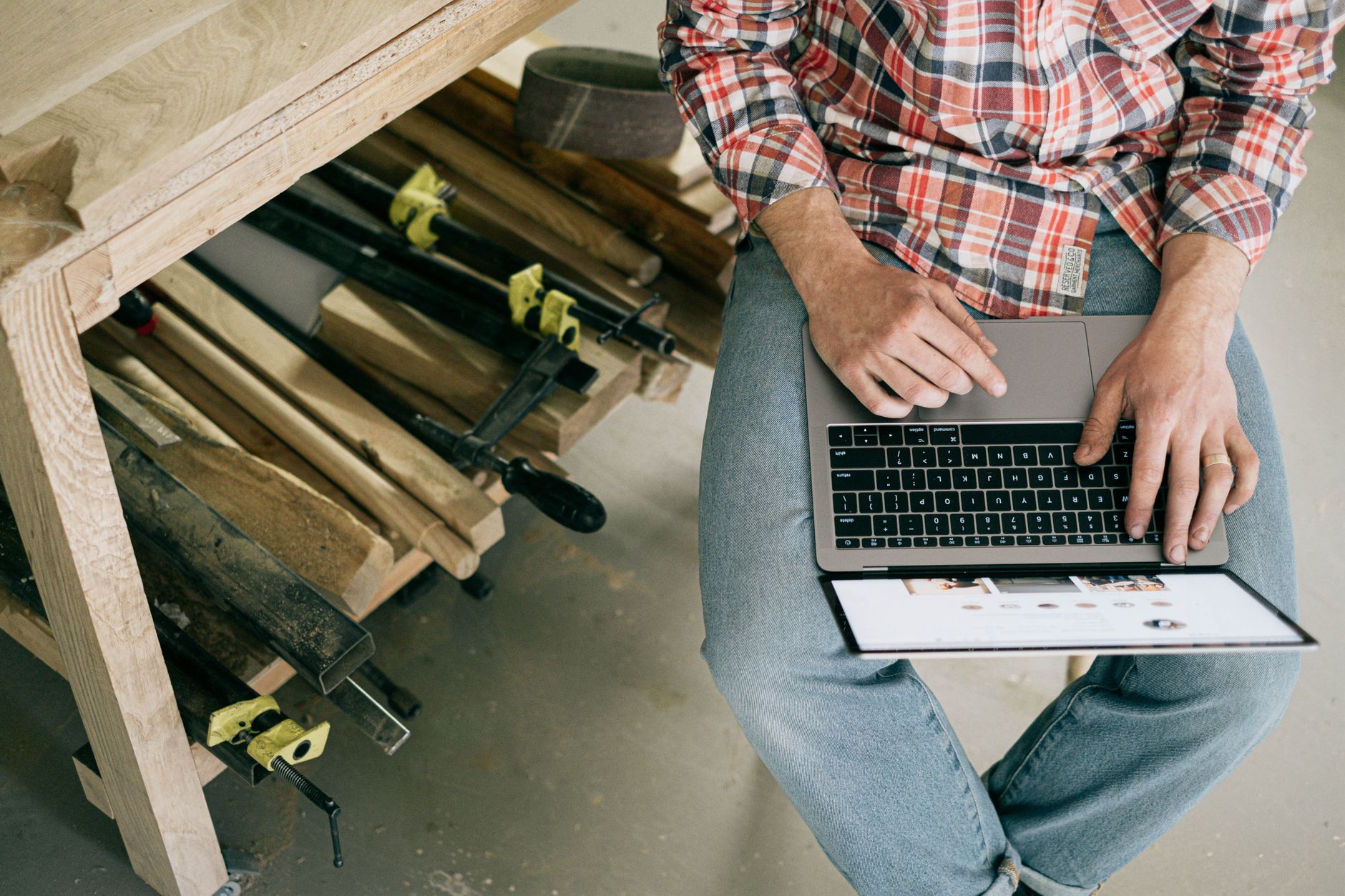 A small business owner drafts a weekly social post on a laptop, keeping a steady rhythm rather than posting everywhere at once.