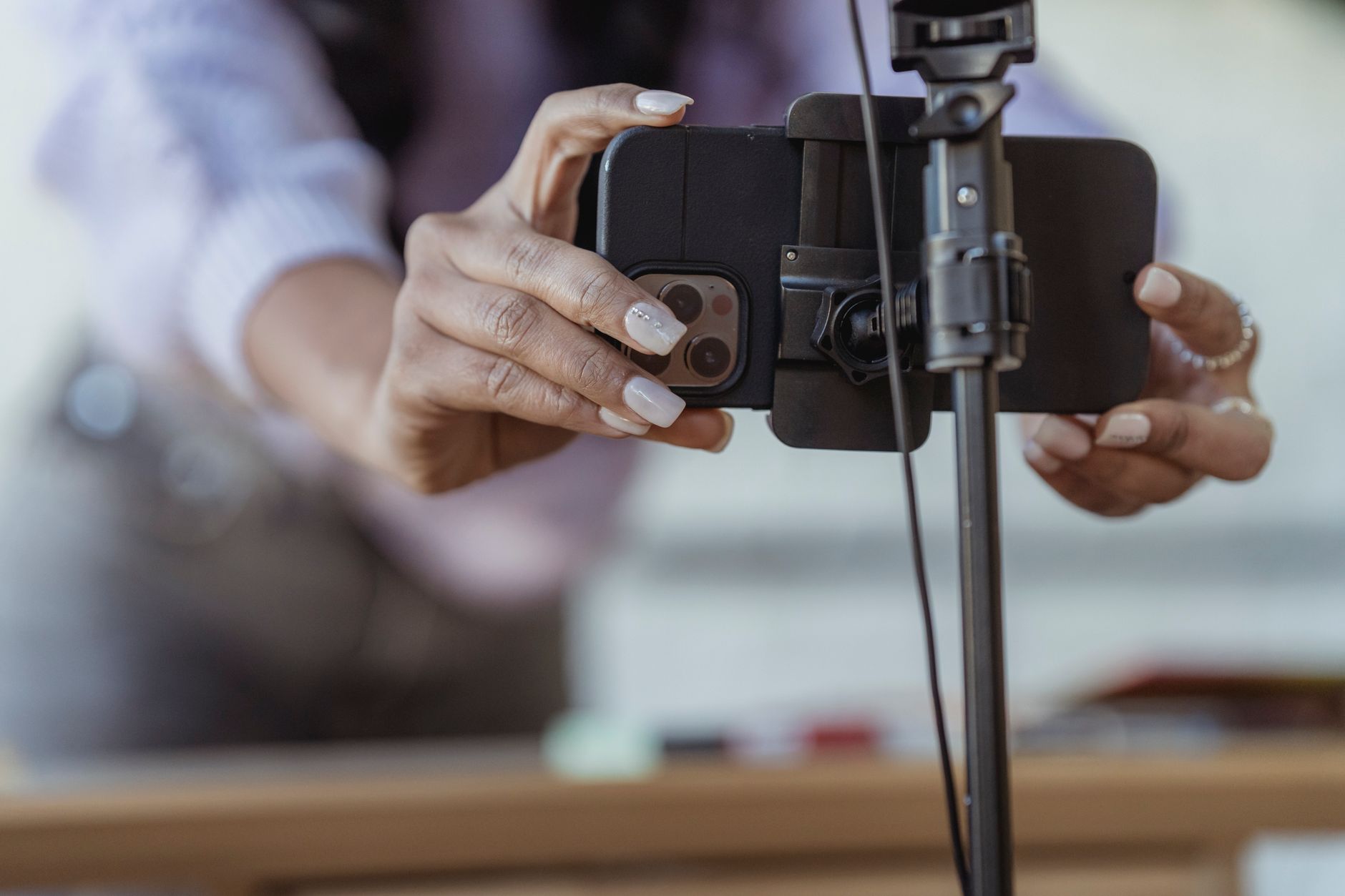 A founder records a short video on a phone propped on a desk, speaking directly to camera about the product they are building.