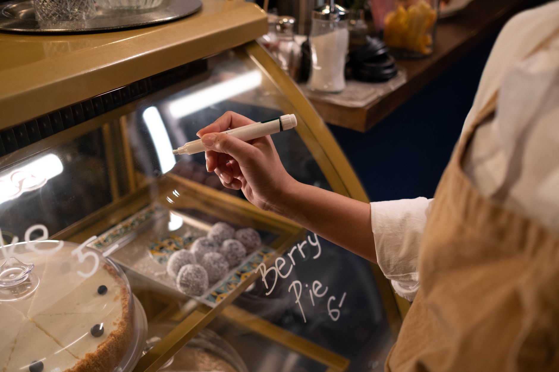 A shop owner writing honest, clear price tags for a sale