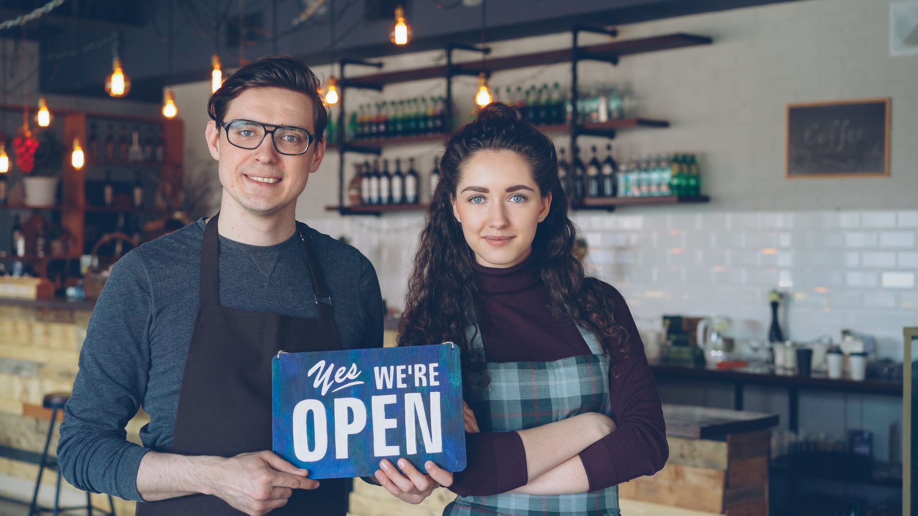 A returning customer is welcomed back by name by the owner of a small independent business.