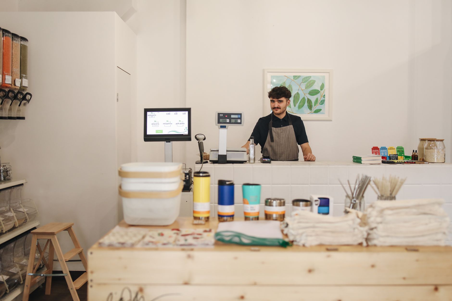 A shop owner updating their business listing at the counter