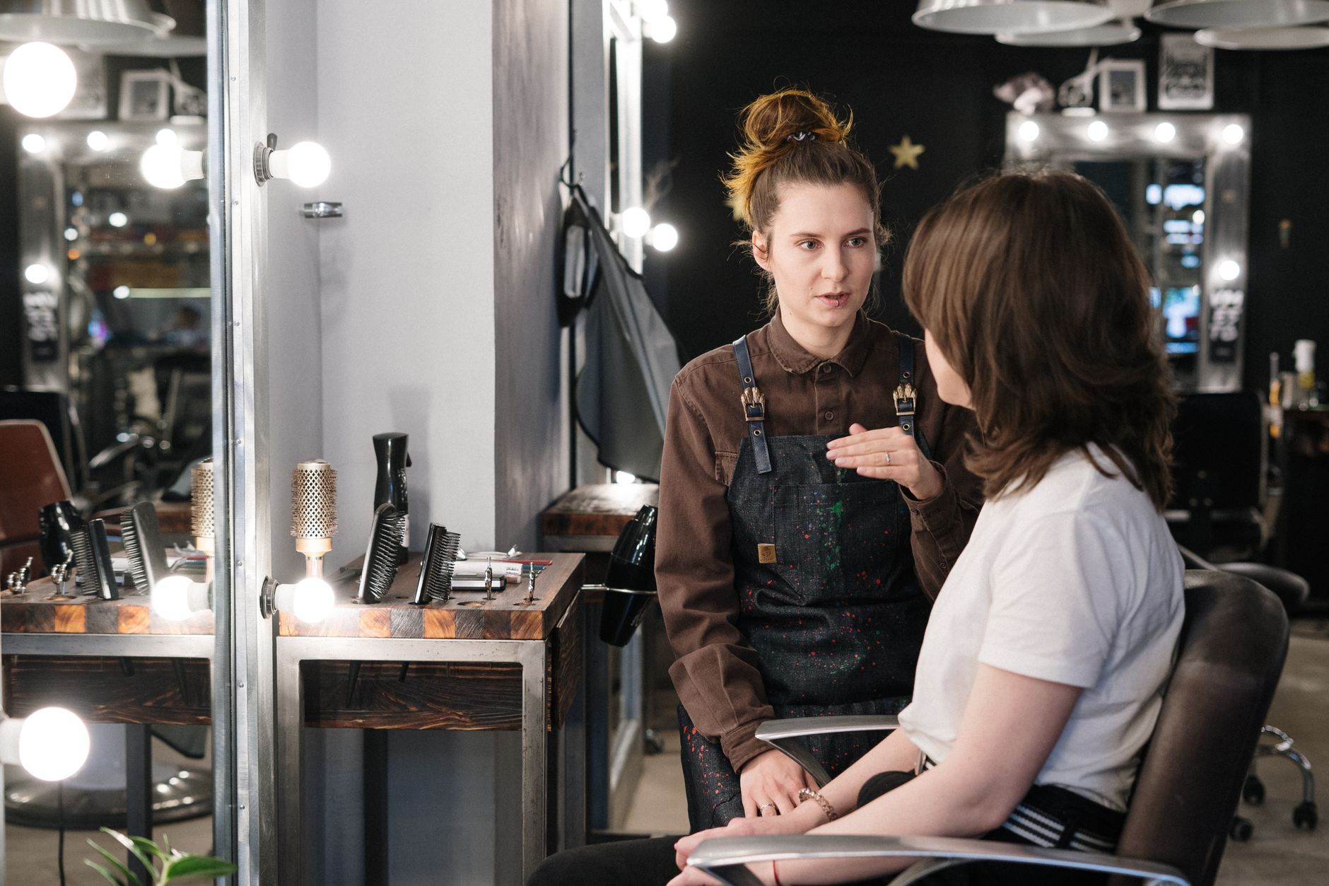 A hairdresser having a calm conversation with a client