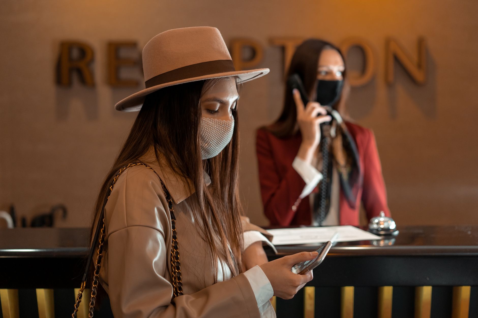 A hotel receptionist reviewing guest feedback at the front desk