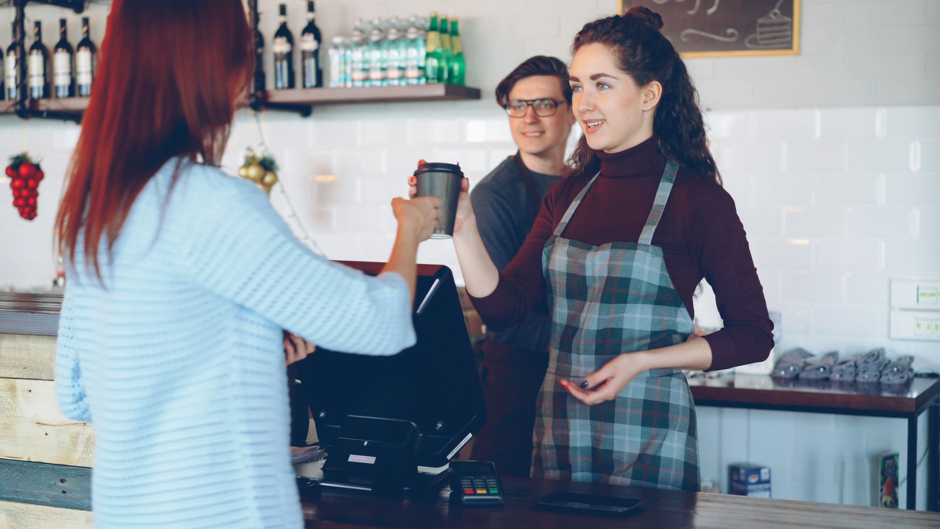 A cafe owner serving a customer who came back after reading a reply