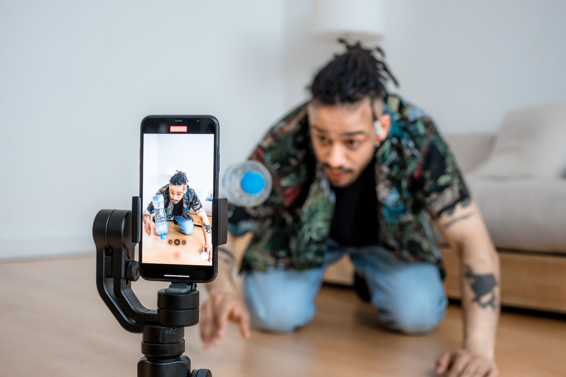 A maker films a short video of a candle on a phone to share on social media, building an audience beyond the marketplace.