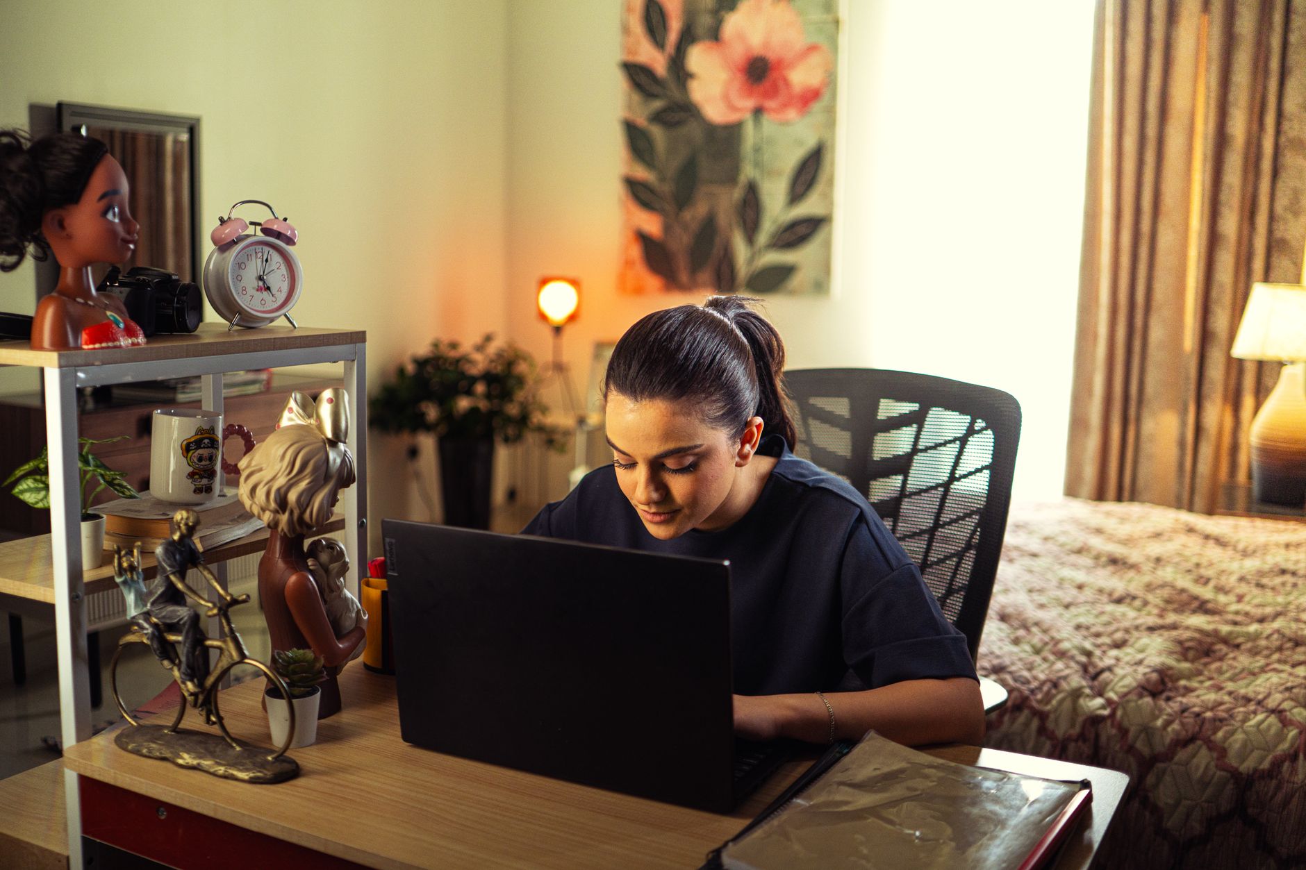 A person working in a spare room set up as a small home office where a business is growing