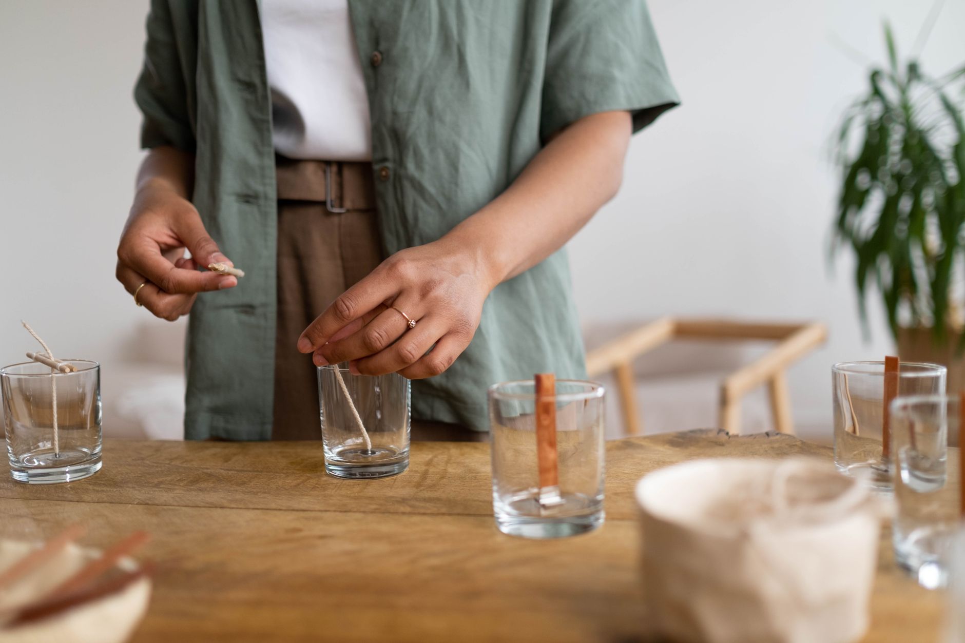 A person photographing handmade goods at home using equipment they already own