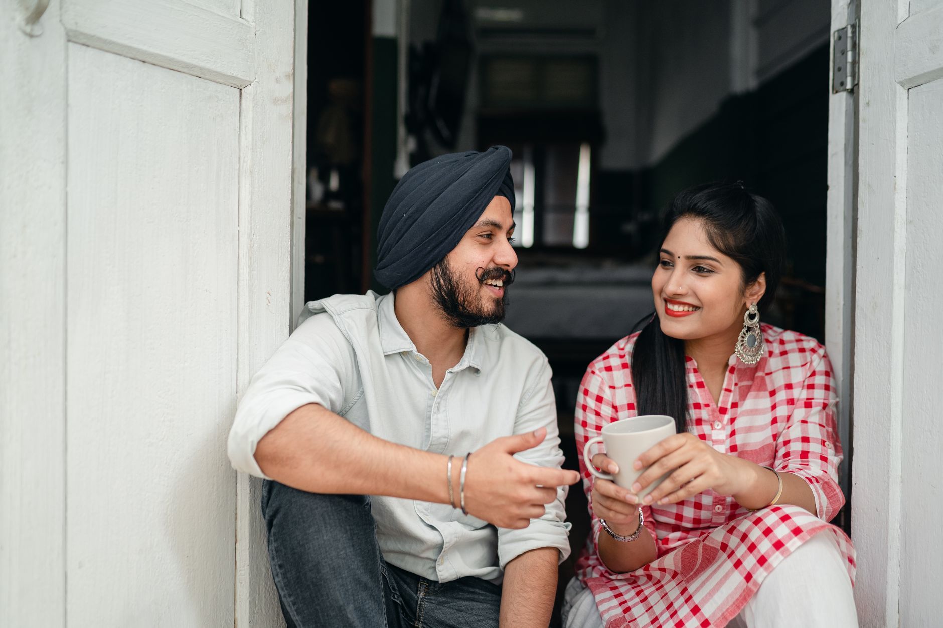 Two neighbours chatting on a doorstep, the word of mouth that gets a new business found for free